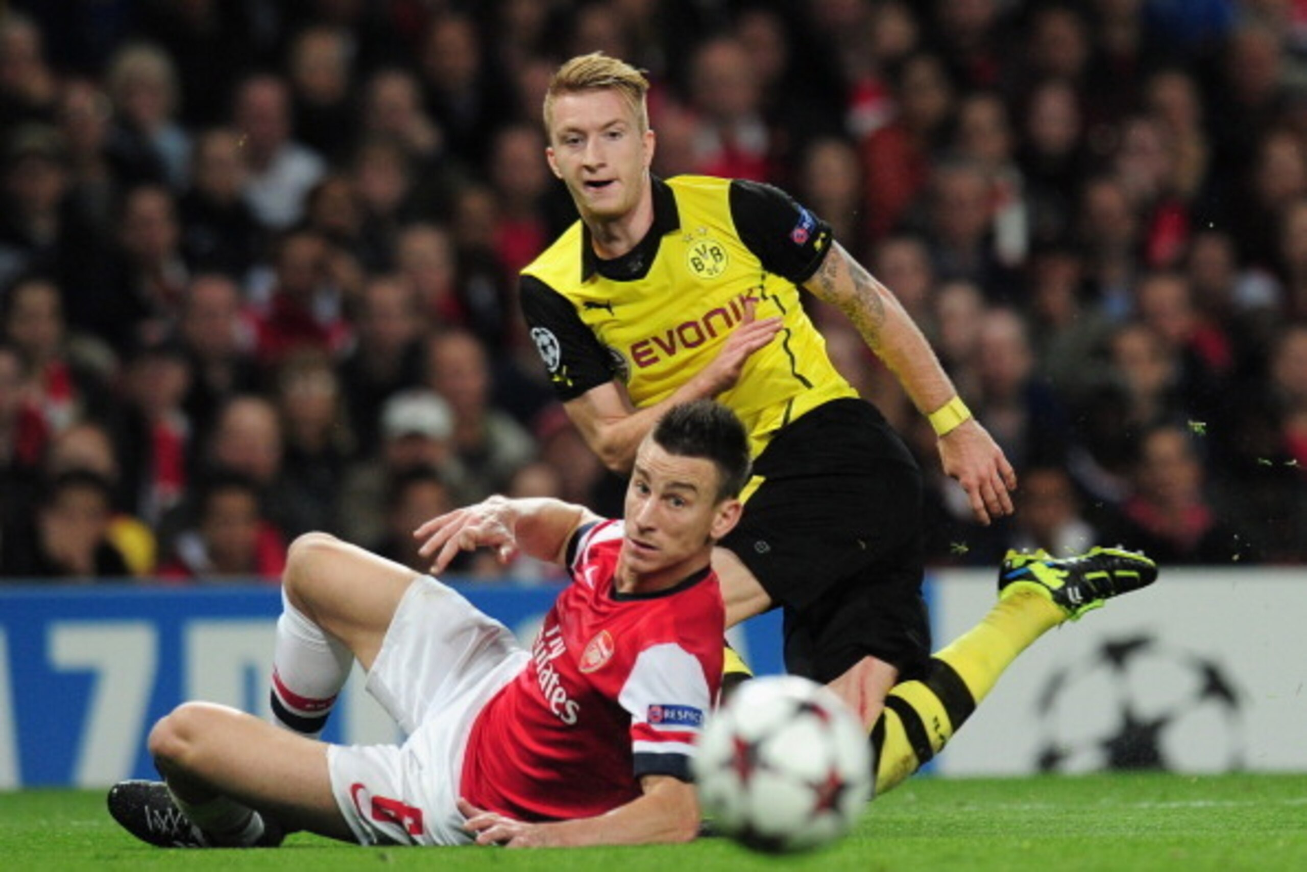LONDON, ENGLAND - OCTOBER 22: Marco Reus of Borussia Dortmund and Laurent Koscielny of Arsenal in action during the UEFA Champions League Group F match between Arsenal and  Borussia Dortmund at Emirates Stadium on October 22, 2013 in London, England.  (Ph