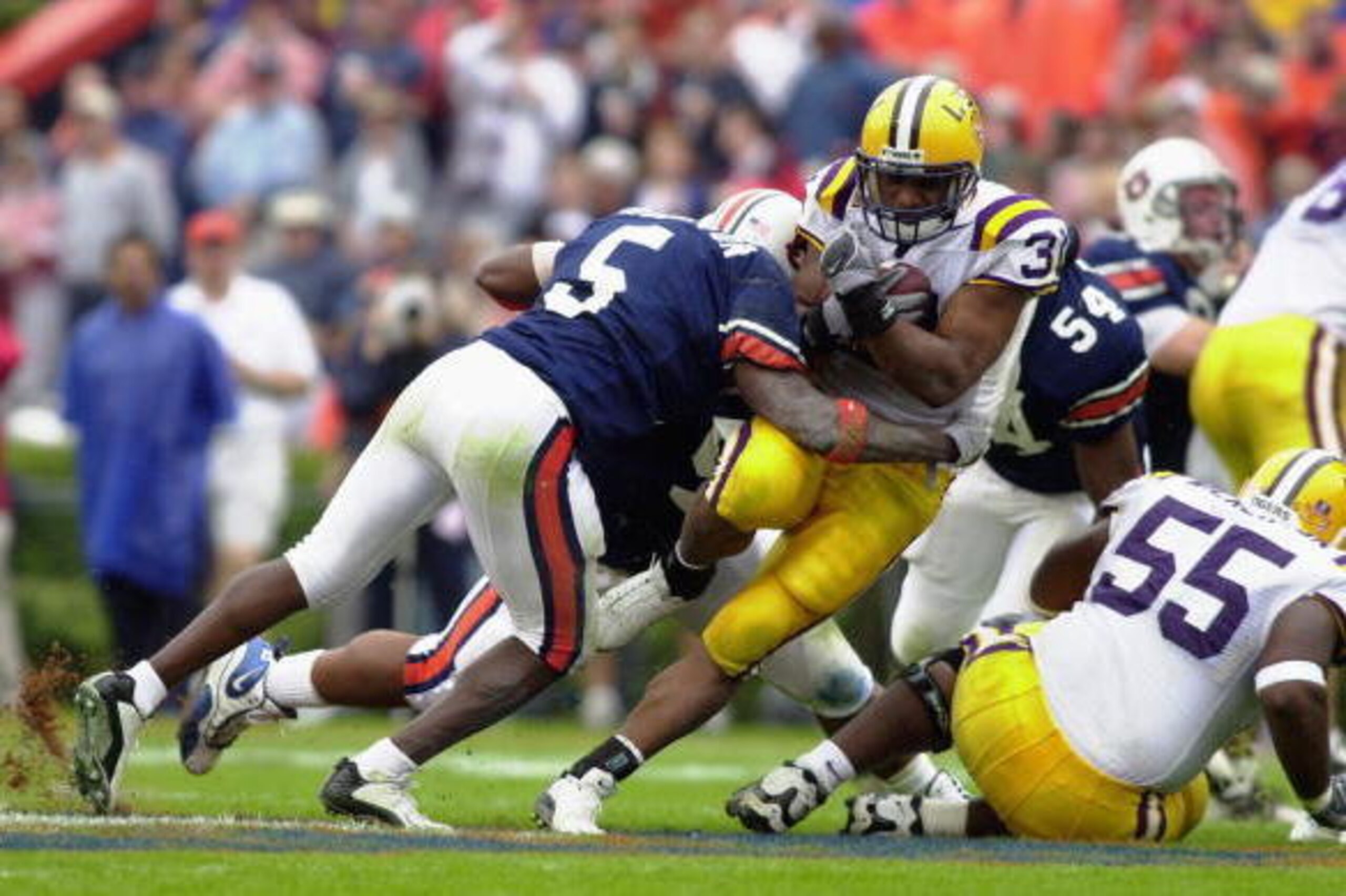 AUBURN, AL - OCTOBER 26:  Running back Domanick Davis #31 of LSU is tackled by free safety Travaris Robinson #5 of Auburn at the SEC game on October 26, 2002 at Jordan-Hare Stadium in Auburn, Alabama .  Auburn beat LSU 31-7.  (Photo by Erik S. Lesser/Gett