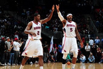 ATLANTA, GA - APRIL 24: Joe Johnson #2 of the Atlanta Hawks celebrates with teammate Josh Smith #5 during a game against the Los Angeles Clippers on April 24, 2012 at Philips Arena in Atlanta, Georgia.  NOTE TO USER: User expressly acknowledges and agrees