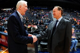 ATLANTA, GA - OCTOBER 17: Mike Budenholzer of the Atlanta Hawks and Gregg Popovich of the San Antonio Spurs shake hands on October 17, 2013 at Philips Arena in Atlanta, Georgia.  NOTE TO USER: User expressly acknowledges and agrees that, by downloading an