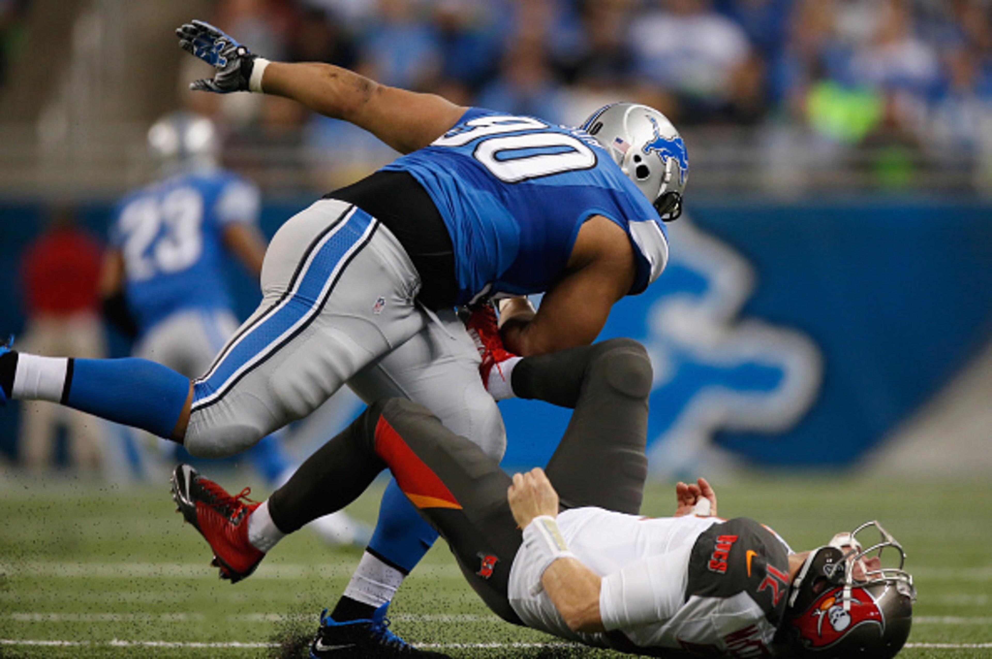 DETROIT, MI - DECEMBER 07: Ndamukong Suh #90 of the Detroit Lions sacks a Josh McCown #12 of the Tampa Bay Buccaneers. Ndamukong Suh #90 was given a penalty for roughing the passer at Ford Field on December 07, 2014 in Detroit, Michigan. (Photo by Gregory