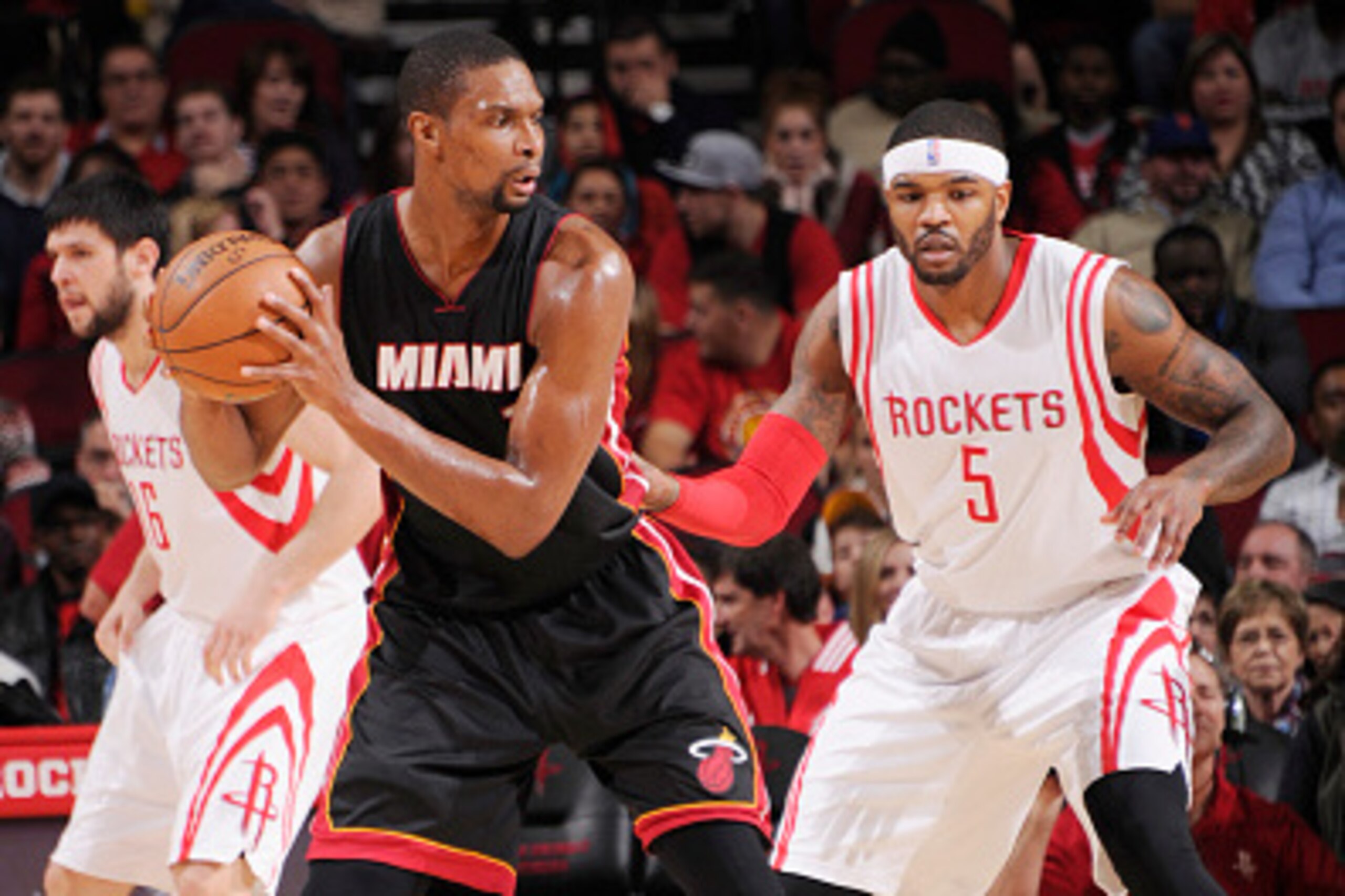 HOUSTON, TX - JANUARY 3: Chris Bosh #1 of the Miami Heat looks to move the ball against Josh Smith #5 of the Houston Rockets during the game on January 3, 2015 at the Toyota Center in Houston, Texas. NOTE TO USER: User expressly acknowledges and agrees th