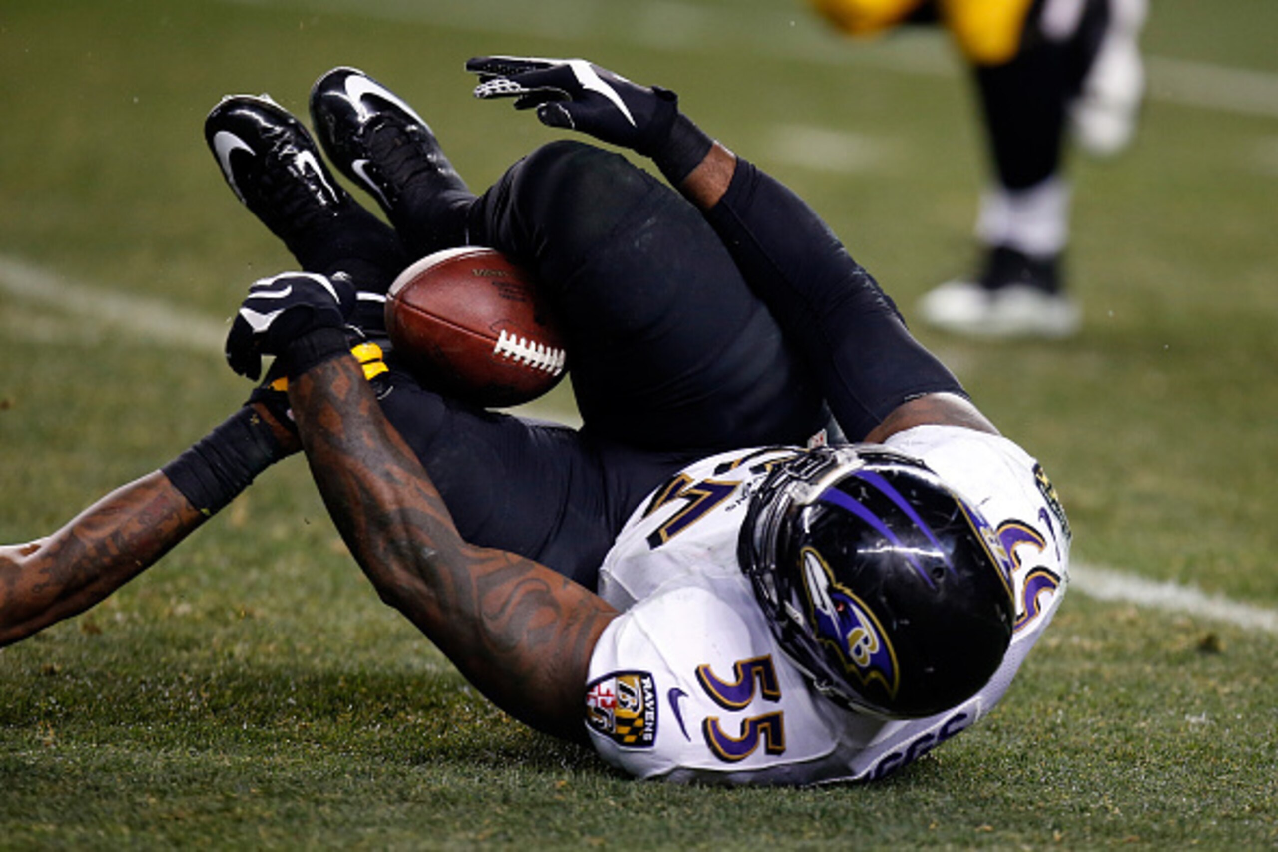 PITTSBURGH, PA - JANUARY 03:  Terrell Suggs #55 of the Baltimore Ravens catches an interception between his legs in the fourth quarter against the Pittsburgh Steelers during their AFC Wild Card game at Heinz Field on January 3, 2015 in Pittsburgh, Pennsyl