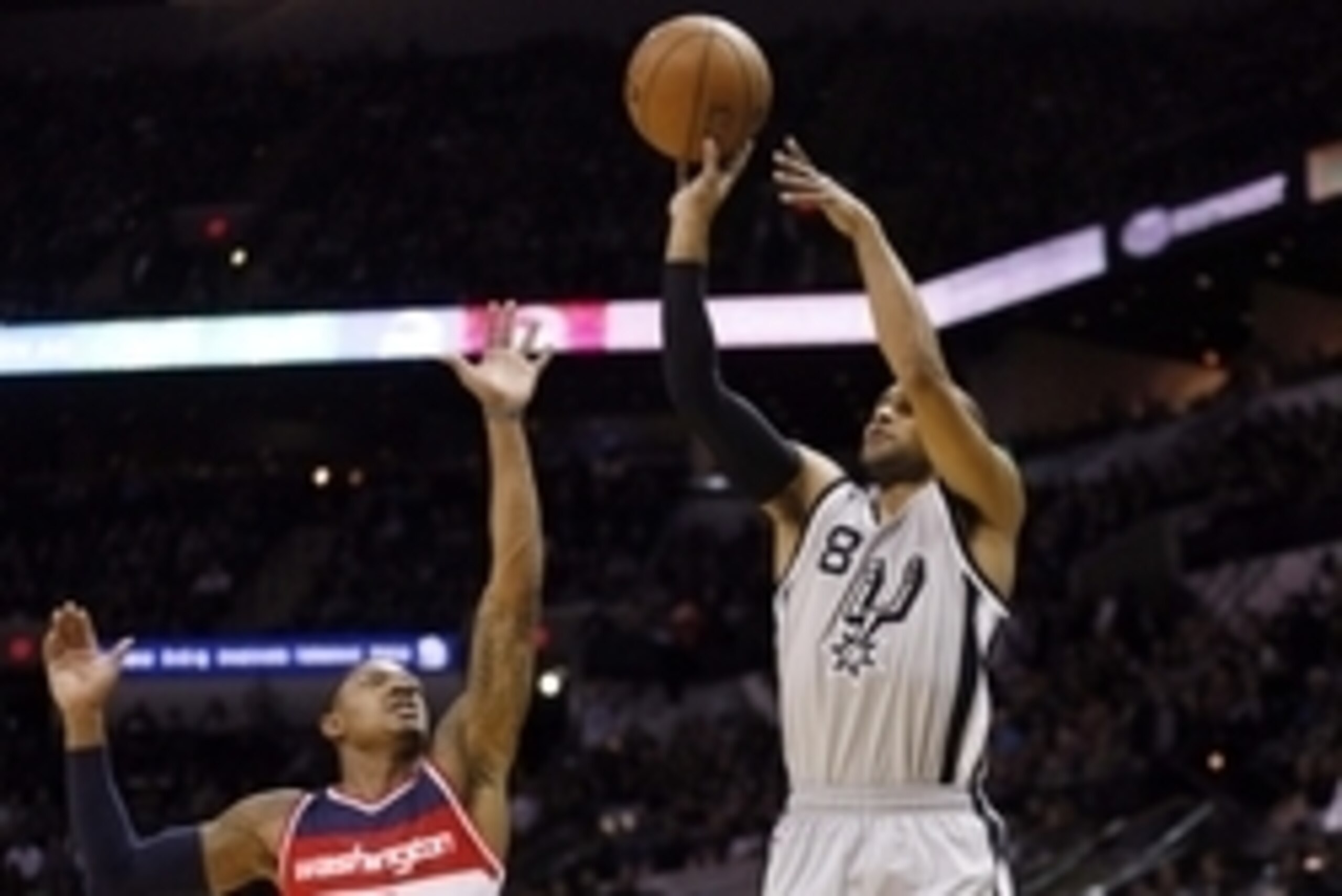 Jan 3, 2015; San Antonio, TX, USA; San Antonio Spurs point guard Patty Mills (8) shoots the ball over Washington Wizards shooting guard Bradley Beal (3) during the first half at AT&T Center. Mandatory Credit: Soobum Im-USA TODAY Sports