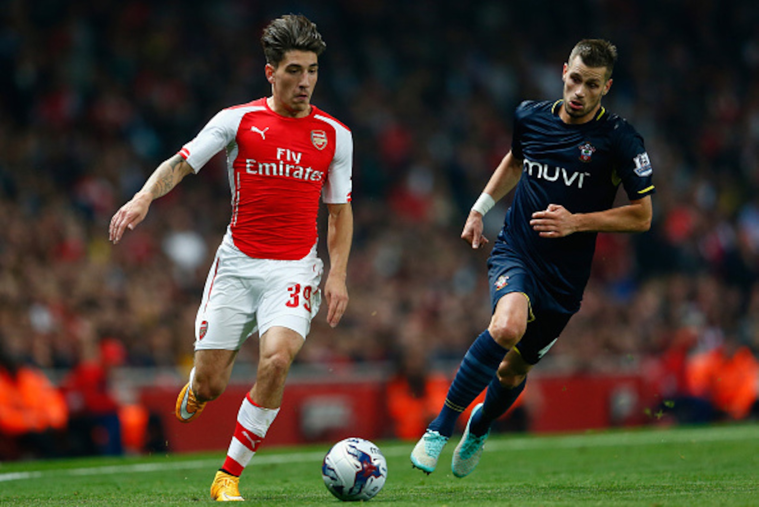 LONDON, ENGLAND - SEPTEMBER 23:  Hector Bellerin of Arsenal moves away from Morgan Schneiderlin of Southampton during the Capital One Cup Third Round match between Arsenal and Southampton at the Emirates Stadium on September 23, 2014 in London, England.  