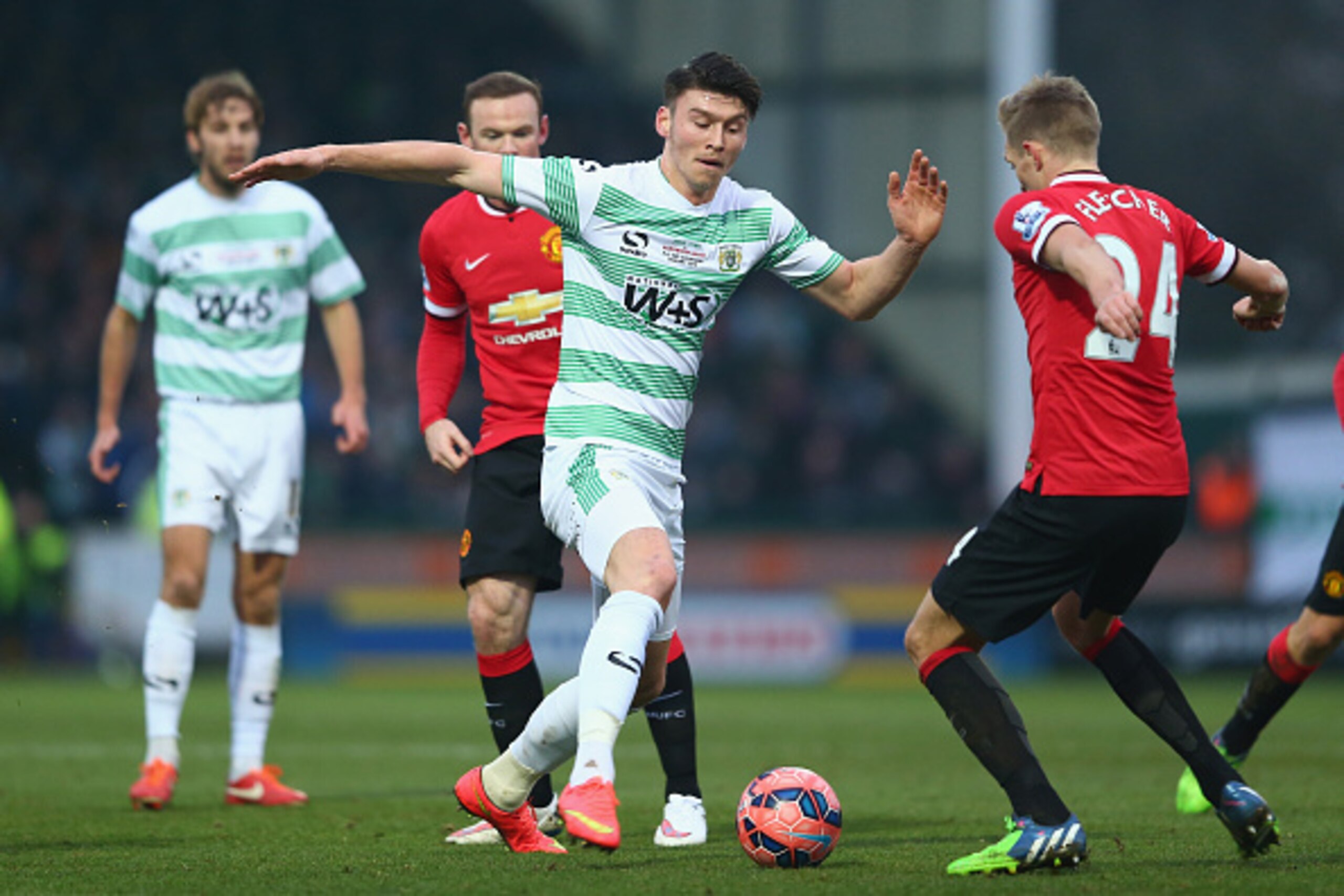 YEOVIL, ENGLAND - JANUARY 04: Kieffer Moore (C) of Yeovil Town runs at Darren Fletcher of Manchester United during the FA Cup Third Round match between Yeovil Town and Manchester United at Huish Park on January 4, 2015 in Yeovil, England.  (Photo by Micha