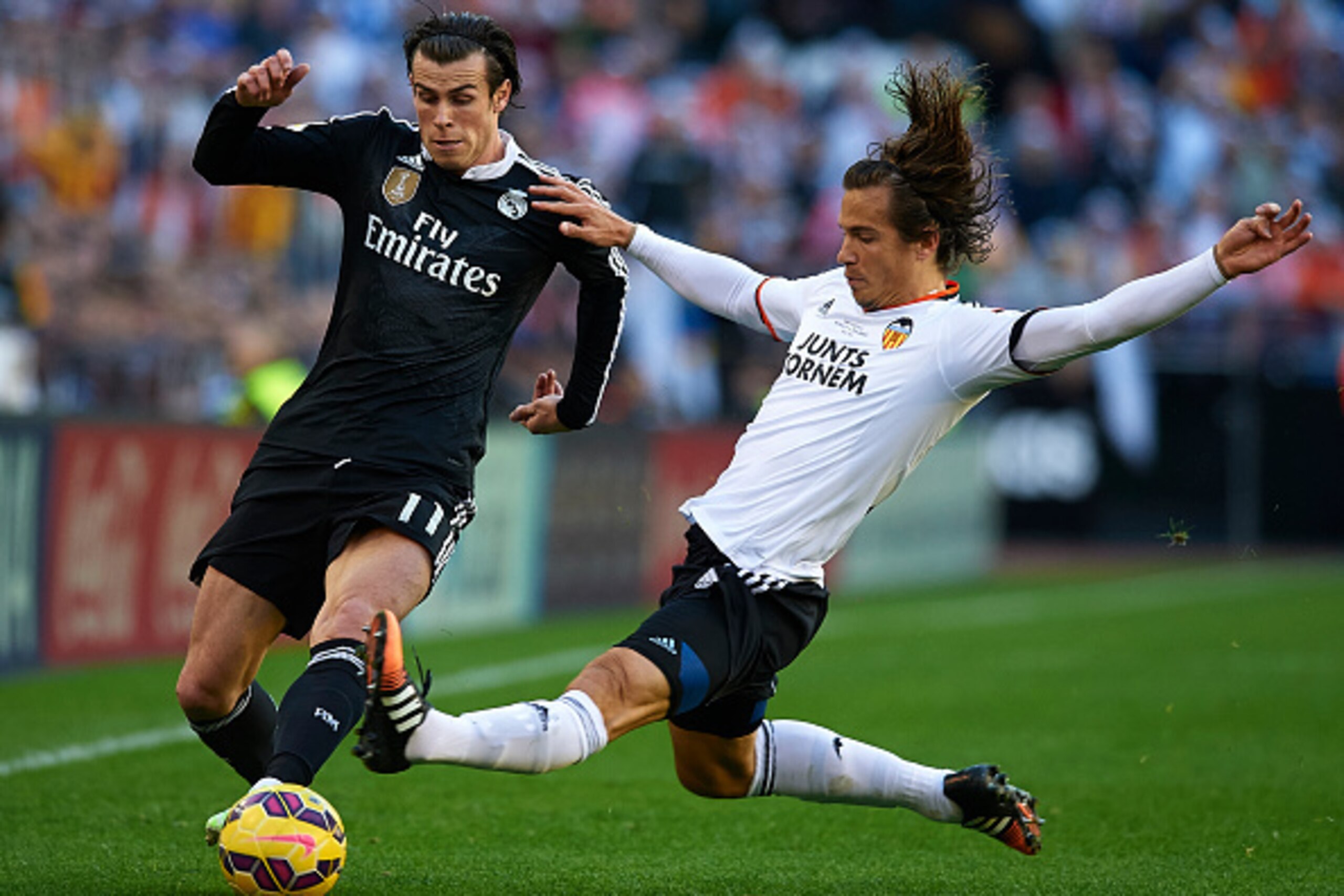 VALENCIA, SPAIN - JANUARY 04:  Lucas Orban of Valencia competes for the ball with Gareth Bale (L) of Real Madrid during the La Liga match between Valencia CF and Real Madrid CF at Estadi de Mestalla on January 4, 2015 in Valencia, Spain.  (Photo by Manuel