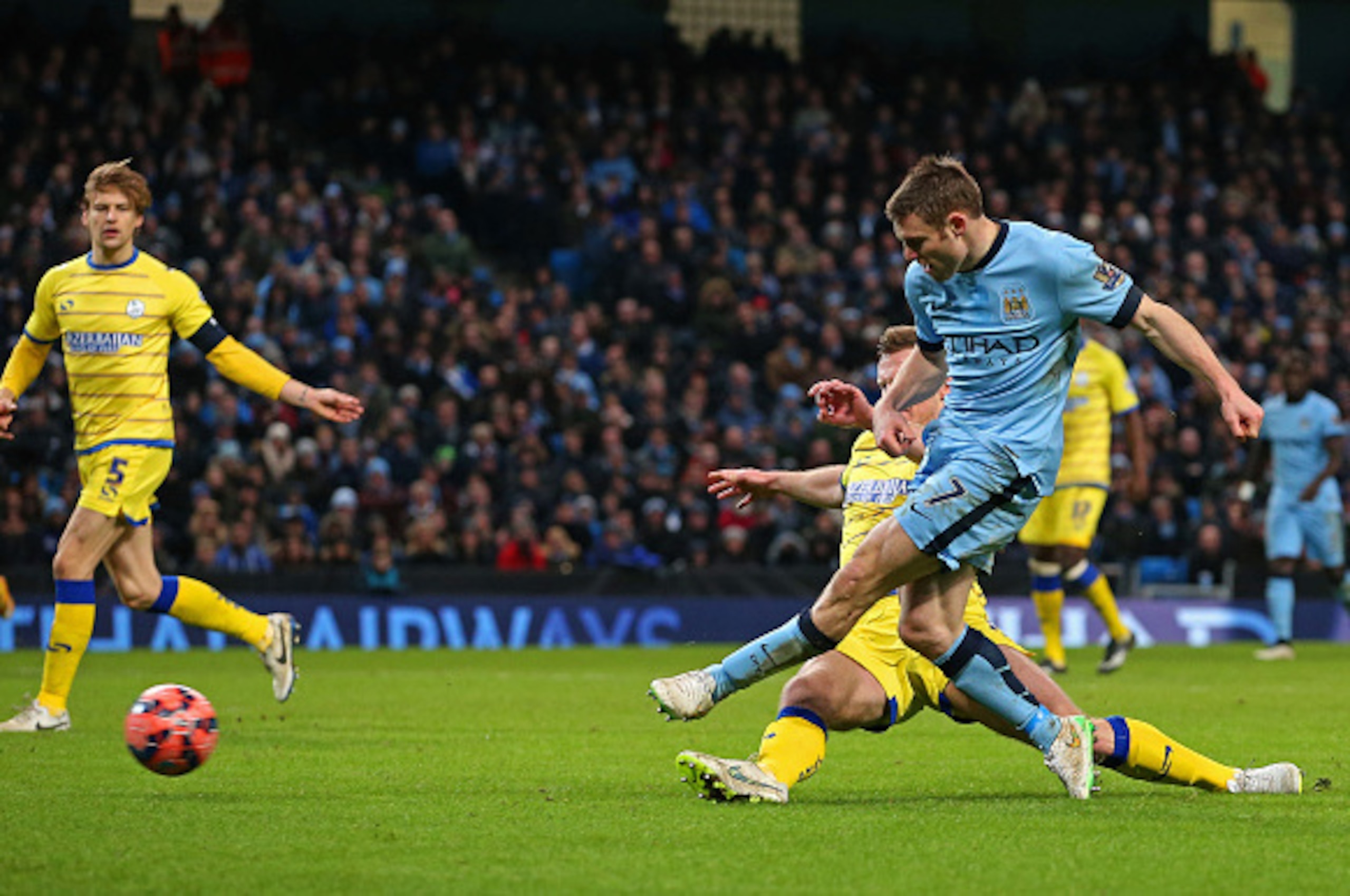 MANCHESTER, ENGLAND - JANUARY 04:  James Milner of Manchester City scores a goal to level the scores at 1-1 during the FA Cup Third Round match between  Manchester City and Sheffield Wednesday at Etihad Stadium on January 4, 2015 in Manchester, England.  