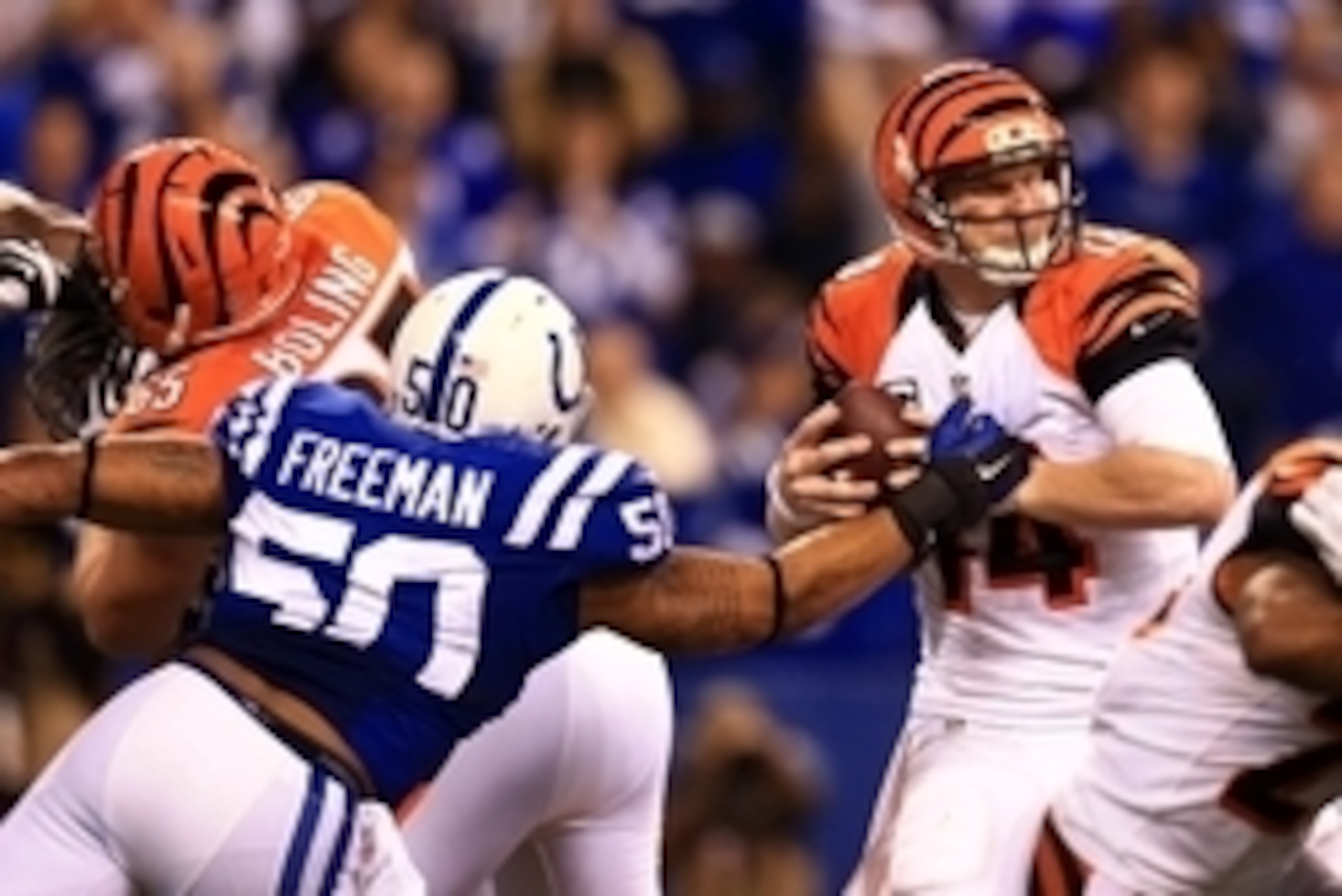 Jan 4, 2015; Indianapolis, IN, USA; Cincinnati Bengals quarterback Andy Dalton (14) is sacked by Indianapolis Colts inside linebacker Jerrell Freeman (50) during the second half in the 2014 AFC Wild Card playoff football game at Lucas Oil Stadium. Mandato