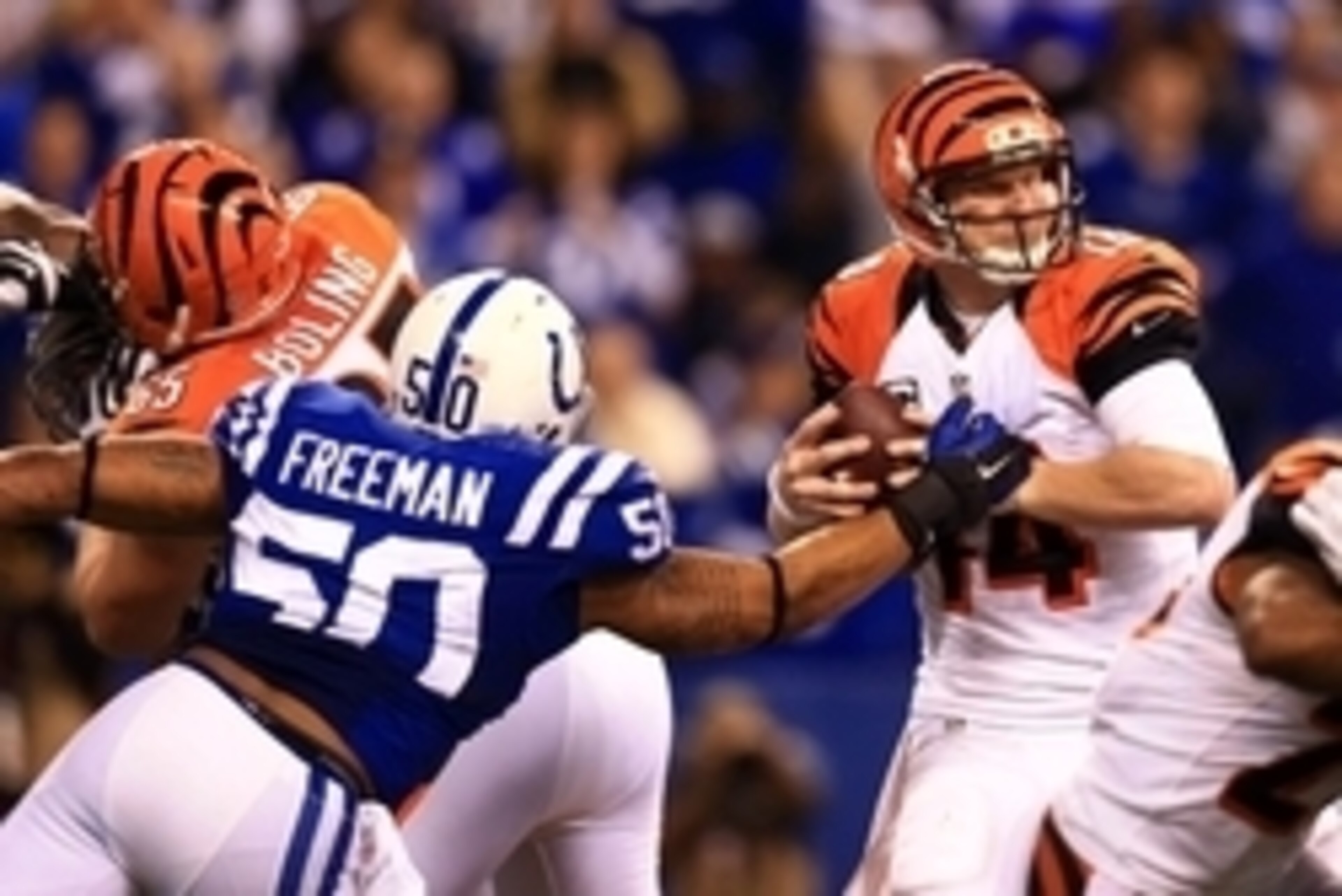 Jan 4, 2015; Indianapolis, IN, USA; Cincinnati Bengals quarterback Andy Dalton (14) is sacked by Indianapolis Colts inside linebacker Jerrell Freeman (50) during the second half in the 2014 AFC Wild Card playoff football game at Lucas Oil Stadium. Mandato