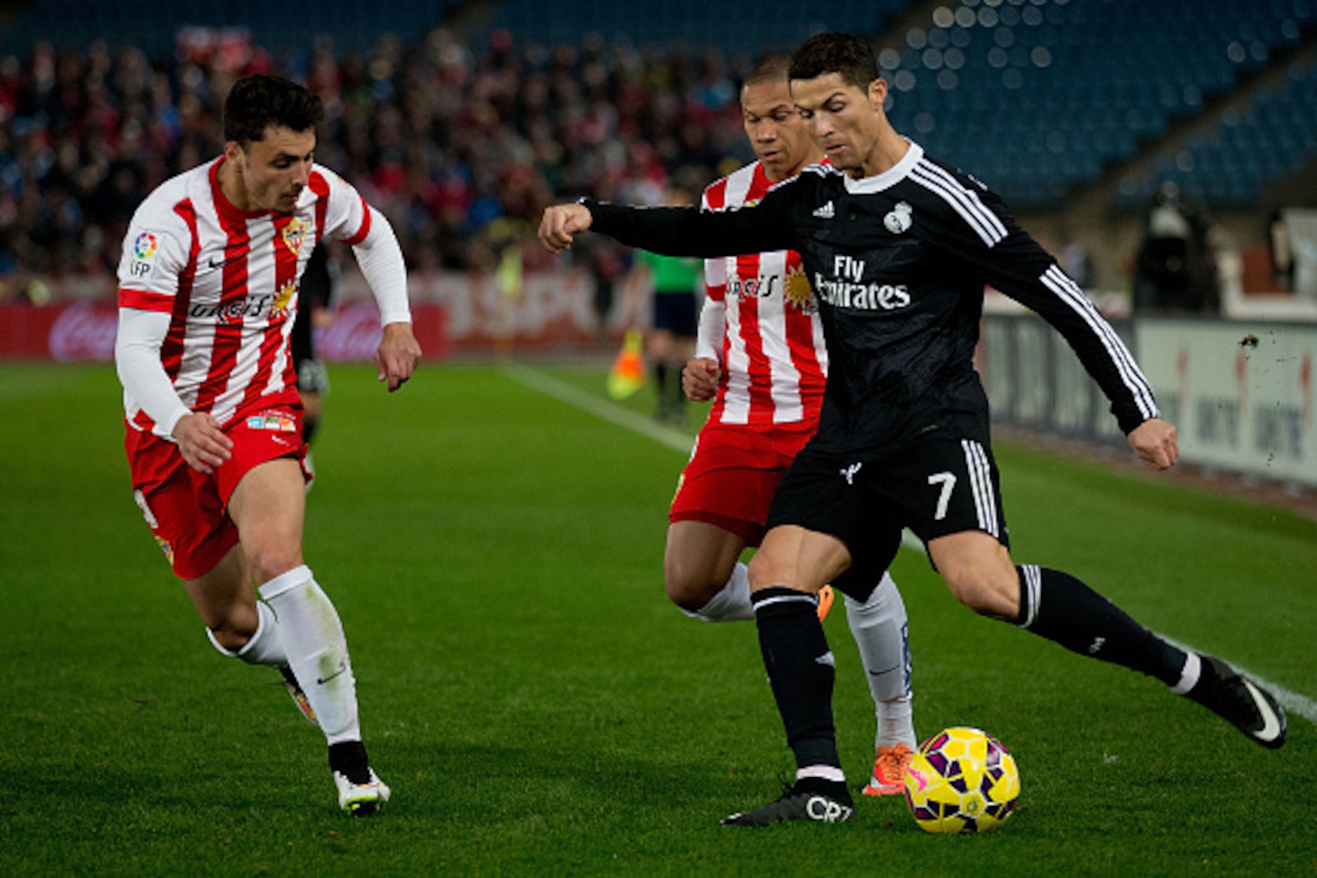 ALMERIA, SPAIN - DECEMBER 12: Cristiano Ronaldo (R) of Real Madrid CF competes for the ball with Wellington Silva (2ndR) of Almeria UD with teammate Joaquin Navarro JImenez (L)during the La Liga match between UD Almeria and Real Madrid CF at Juegos del Me