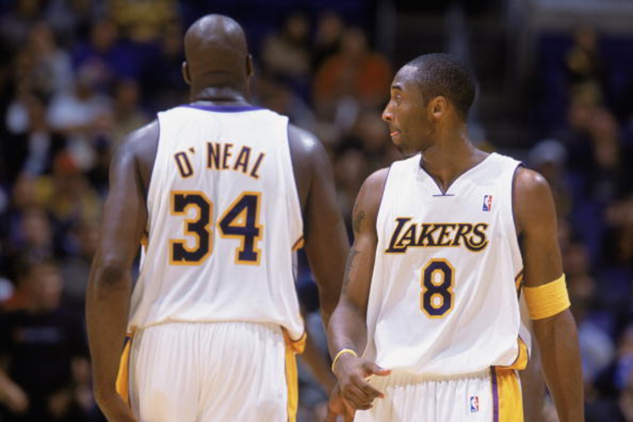 LOS ANGELES - NOVEMBER 2:  Kobe Bryant #8 and Shaquille O'Neal #34 of the Los Angeles Lakers wait for play to begin against the Golden State Warriors during the NBA game at Staples Center on November 2, 2003 in Los Angeles, California. The Lakers won 87-7
