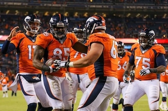 DENVER, CO - DECEMBER 28:  Tight end Virgil Green #85 and Brock Osweiler #17 of the Denver Broncos celebrate a fourth quarter touchdown with teammates during a game against the Oakland Raiders at Sports Authority Field at Mile High on December 28, 2014 in