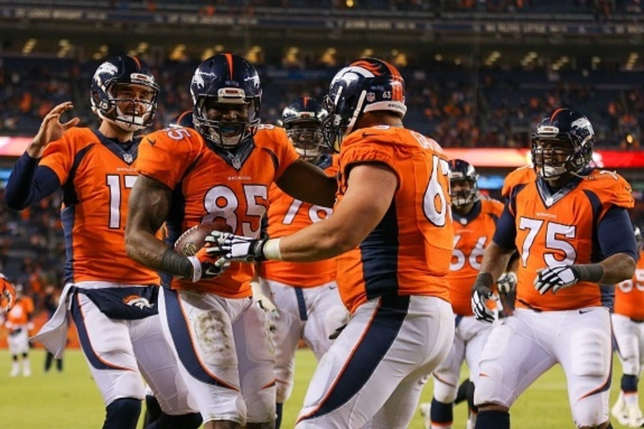 DENVER, CO - DECEMBER 28:  Tight end Virgil Green #85 and Brock Osweiler #17 of the Denver Broncos celebrate a fourth quarter touchdown with teammates during a game against the Oakland Raiders at Sports Authority Field at Mile High on December 28, 2014 in