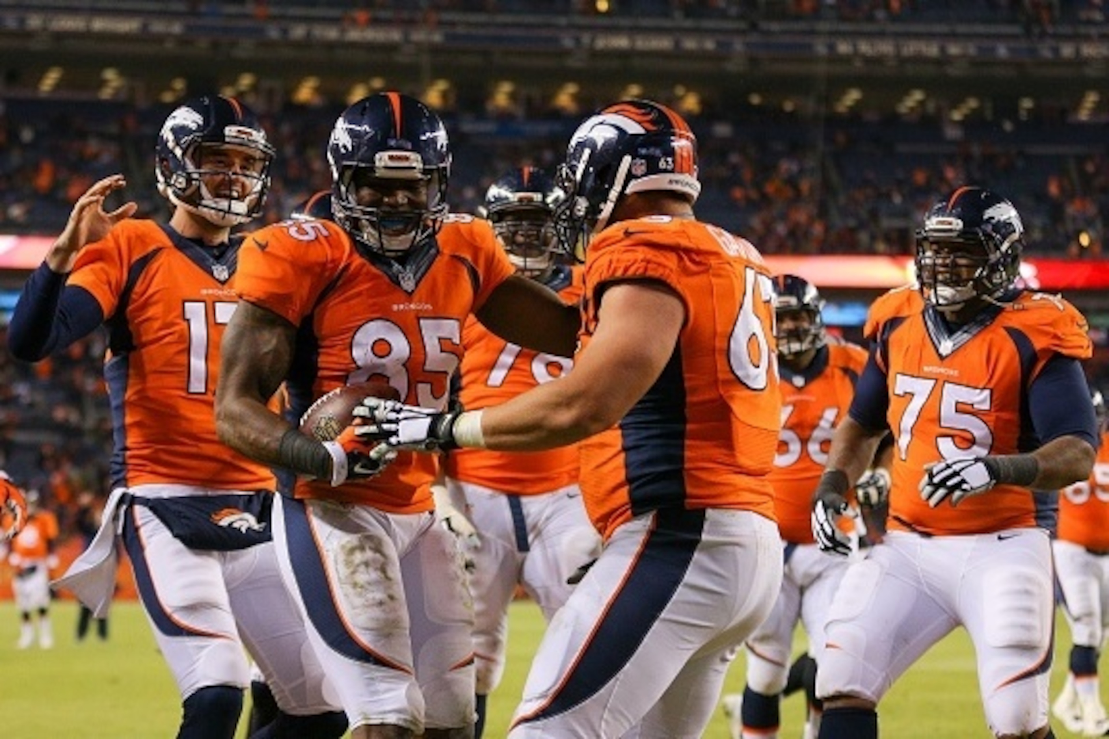 DENVER, CO - DECEMBER 28:  Tight end Virgil Green #85 and Brock Osweiler #17 of the Denver Broncos celebrate a fourth quarter touchdown with teammates during a game against the Oakland Raiders at Sports Authority Field at Mile High on December 28, 2014 in