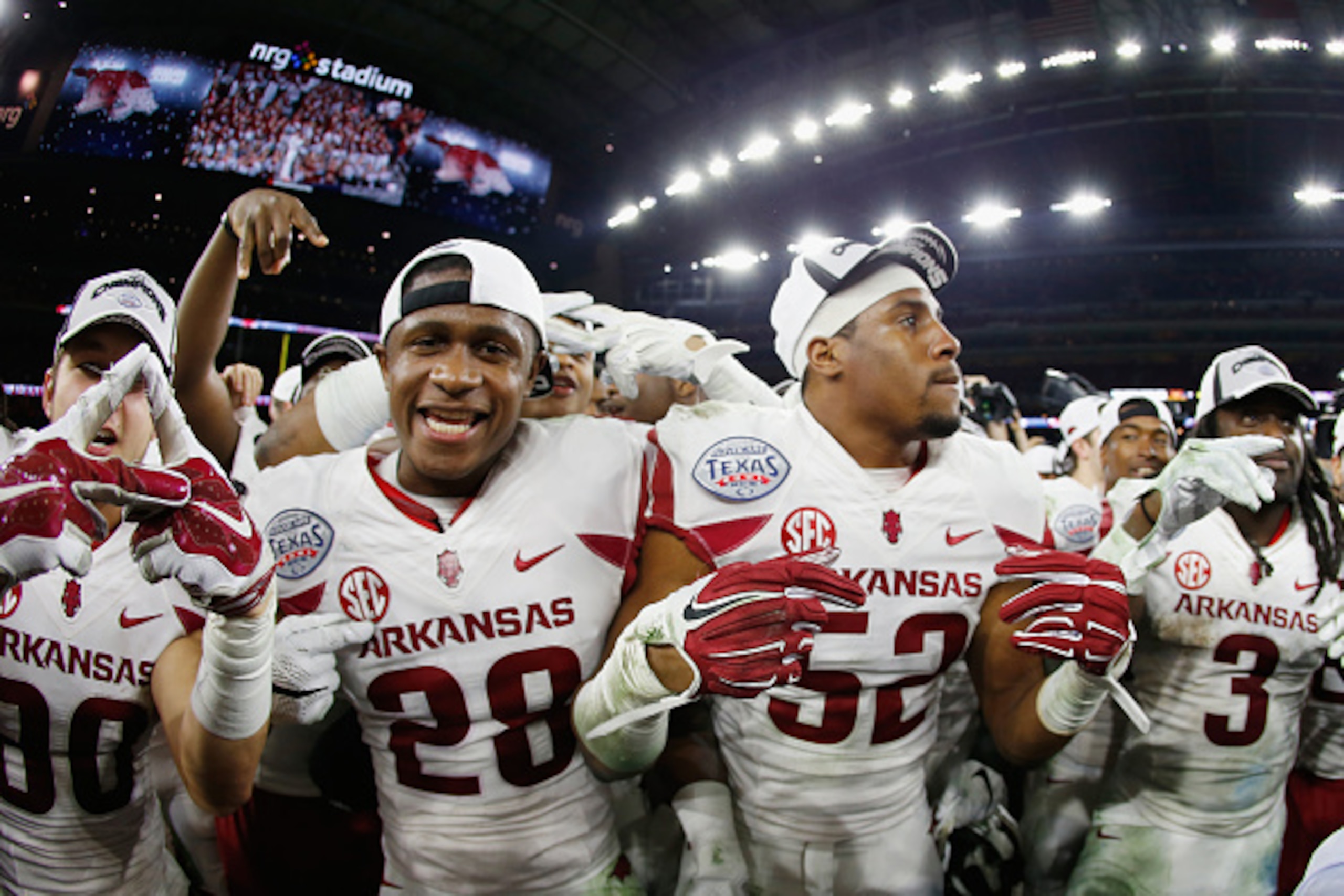 HOUSTON, TX - DECEMBER 29:  Arkansas Razorbacks  players celebrate after the Razorbacks defeated the Texas Longhorns 31-7 at the AdvoCare V100 Texas Bowl at NRG Stadium on December 29, 2014 in Houston, Texas.  (Photo by Scott Halleran/Getty Images)