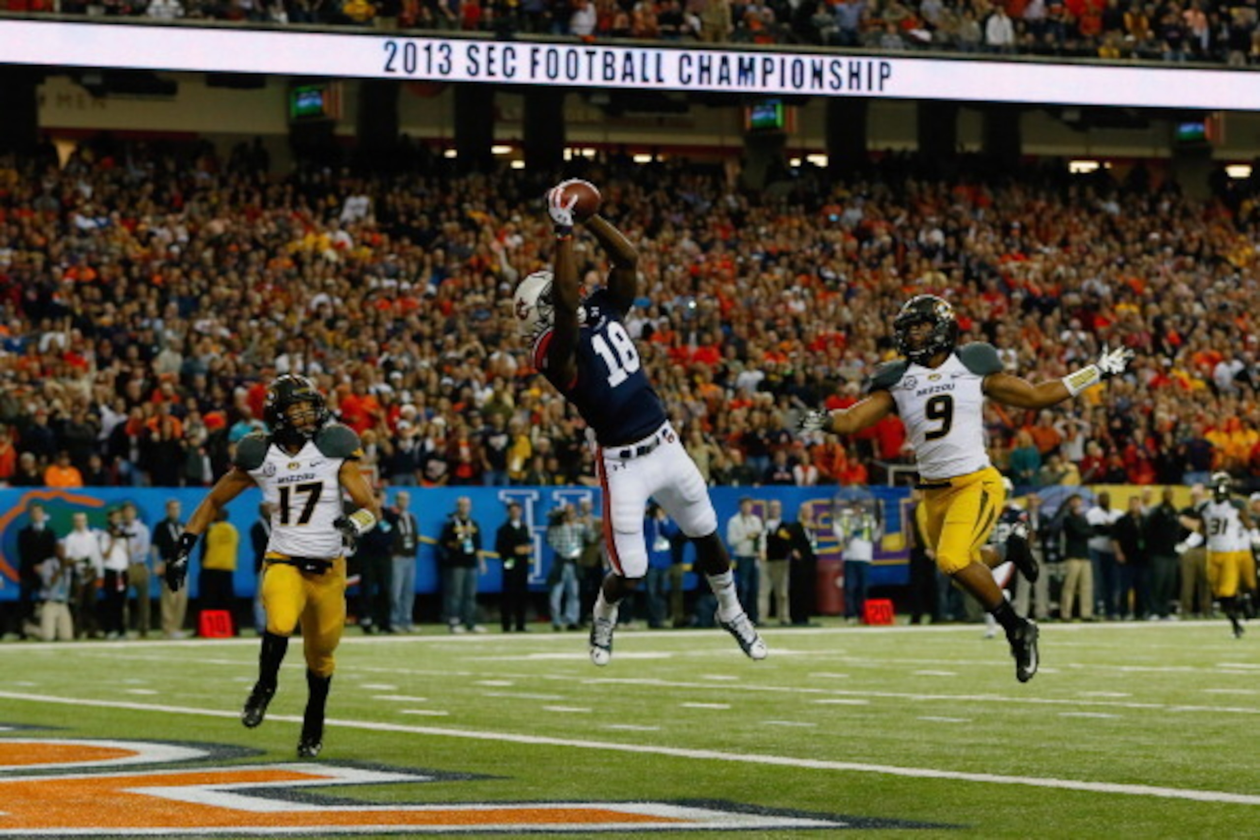 ATLANTA, GA - DECEMBER 07:  Sammie Coates #18 of the Auburn Tigers scores a touchdown against Matt White #17 and Braylon Webb #9 of the Missouri Tigers in the first quarter during the SEC Championship Game at Georgia Dome on December 7, 2013 in Atlanta, G
