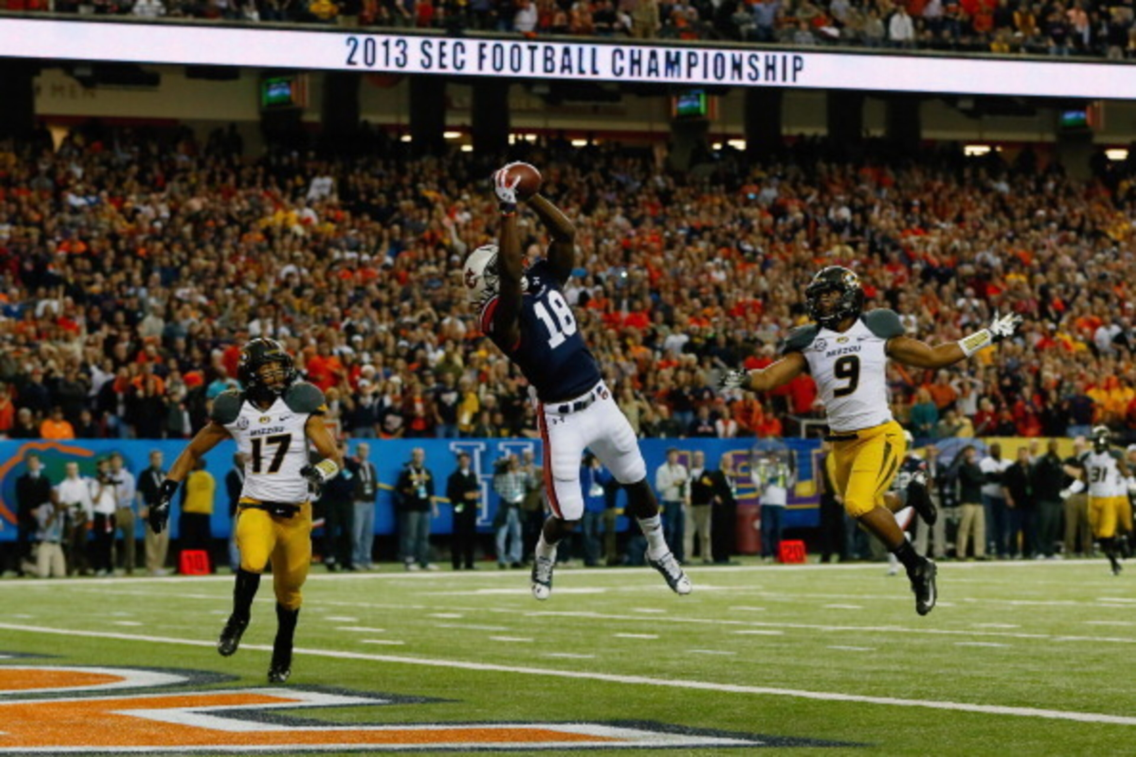 ATLANTA, GA - DECEMBER 07:  Sammie Coates #18 of the Auburn Tigers scores a touchdown against Matt White #17 and Braylon Webb #9 of the Missouri Tigers in the first quarter during the SEC Championship Game at Georgia Dome on December 7, 2013 in Atlanta, G