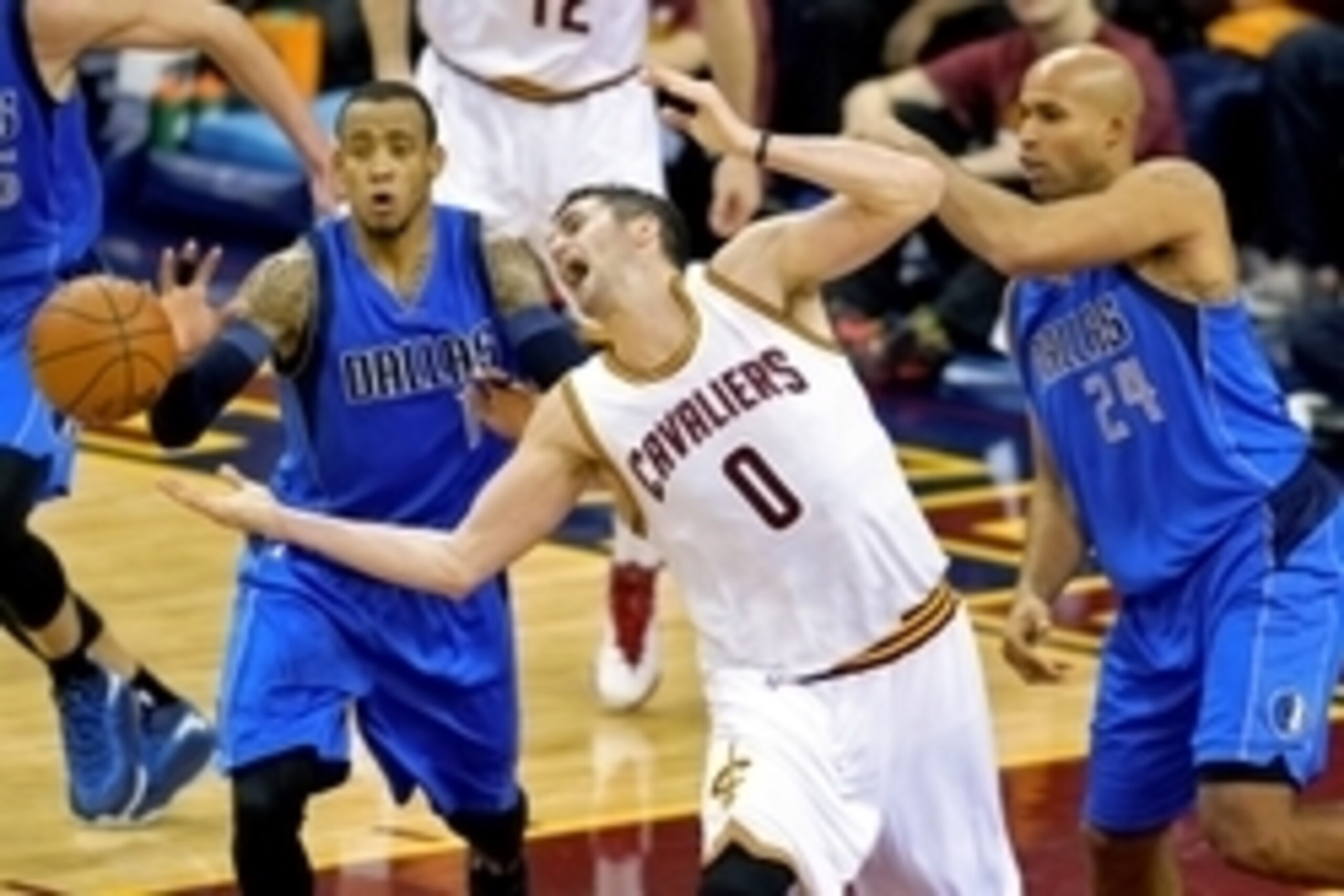 Jan 4, 2015; Cleveland, OH, USA; Cleveland Cavaliers forward Kevin Love (0) reaches for the ball between Dallas Mavericks guard Monta Ellis (11) and forward Richard Jefferson (24) in the third quarter at Quicken Loans Arena. Mandatory Credit: David Richar