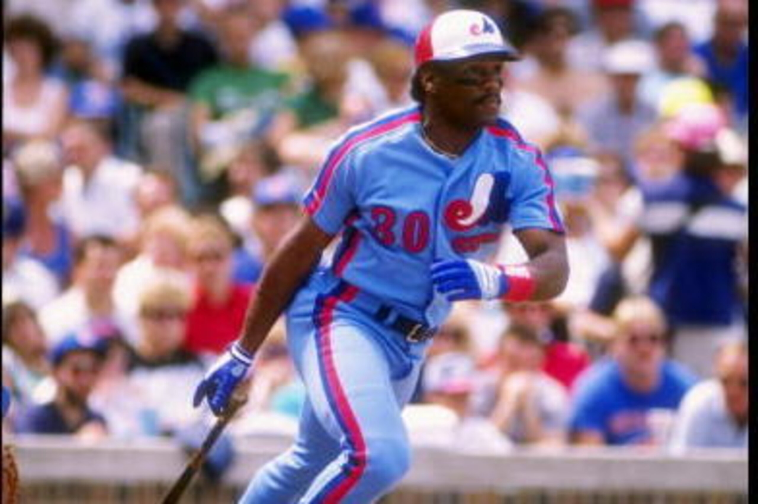 Outfielder Tim Raines of the Montreal Expos drops his bat and prepares to run.