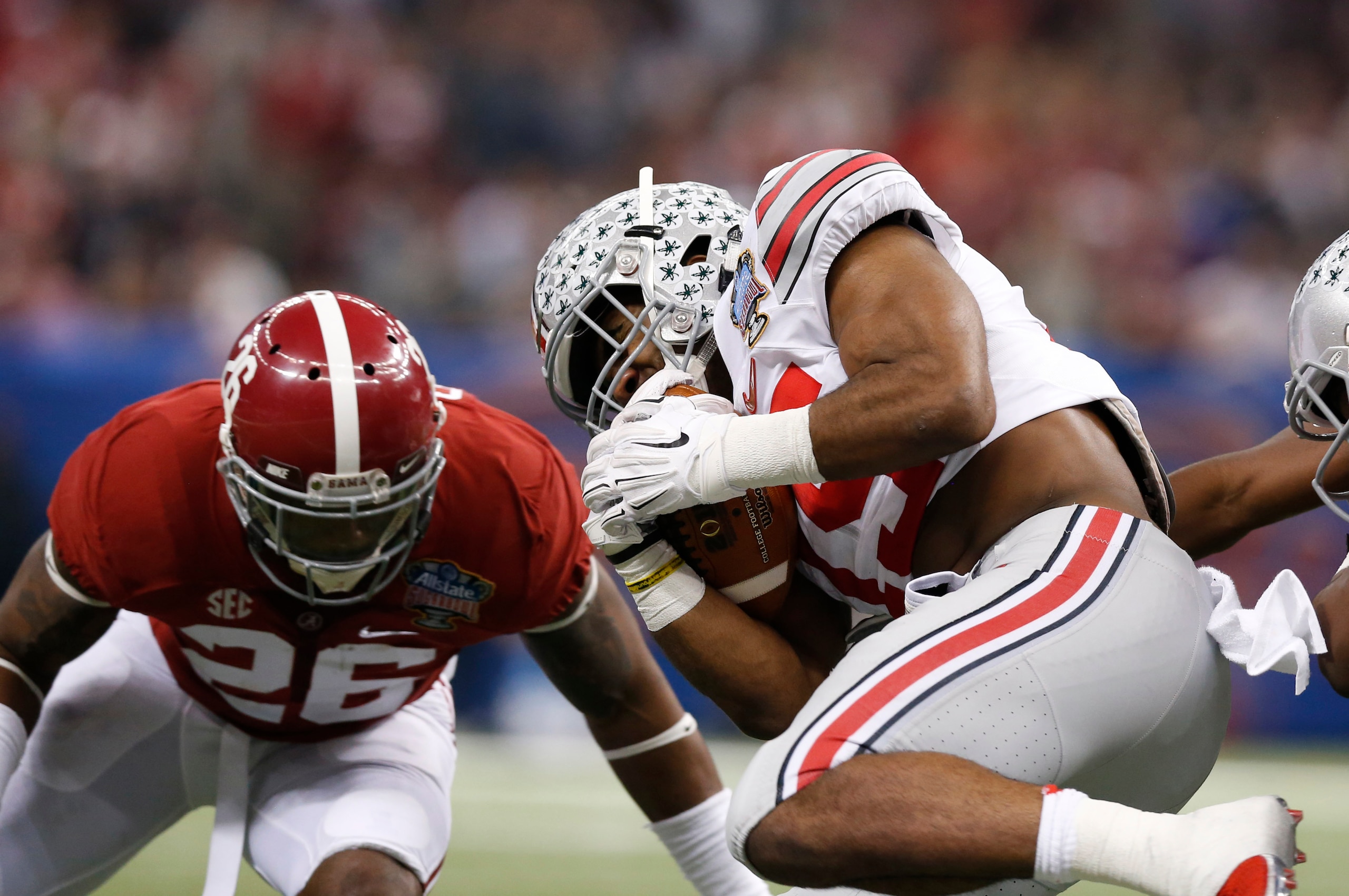 Jan 1, 2015; New Orleans, LA, USA; Ohio State Buckeyes running back Ezekiel Elliott (15) runs with the ball against  Alabama Crimson Tide safety Landon Collins (26) in the 2015 Sugar Bowl at Mercedes-Benz Superdome. Mandatory Credit: Matthew Emmons-USA TO