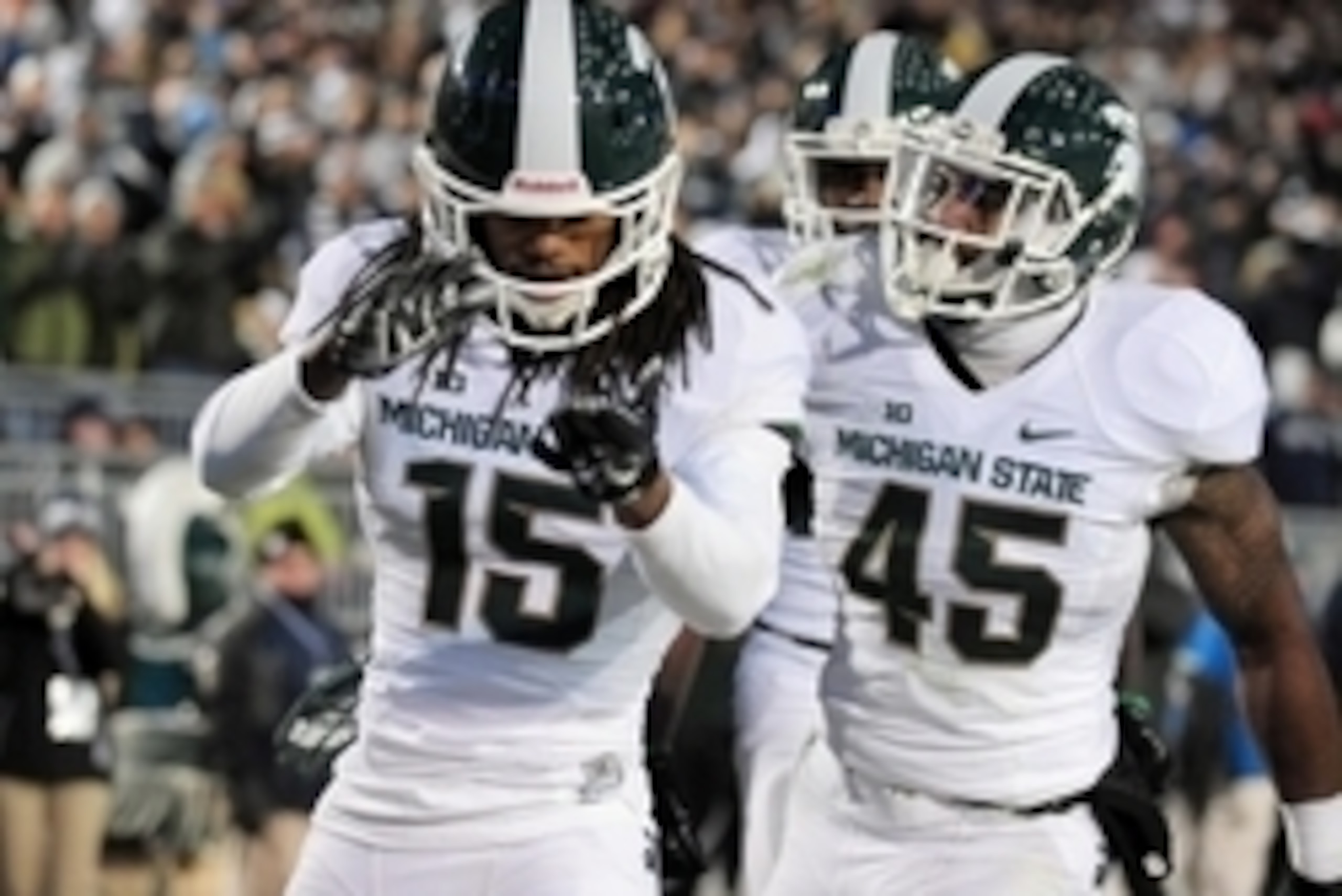 Nov 29, 2014; University Park, PA, USA; Michigan State Spartans cornerback Trae Waynes (15) is congratulated by linebacker Darien Harris (45) after making an interception in the second quarter against the Penn State Nittany Lions at Beaver Stadium. Mandat