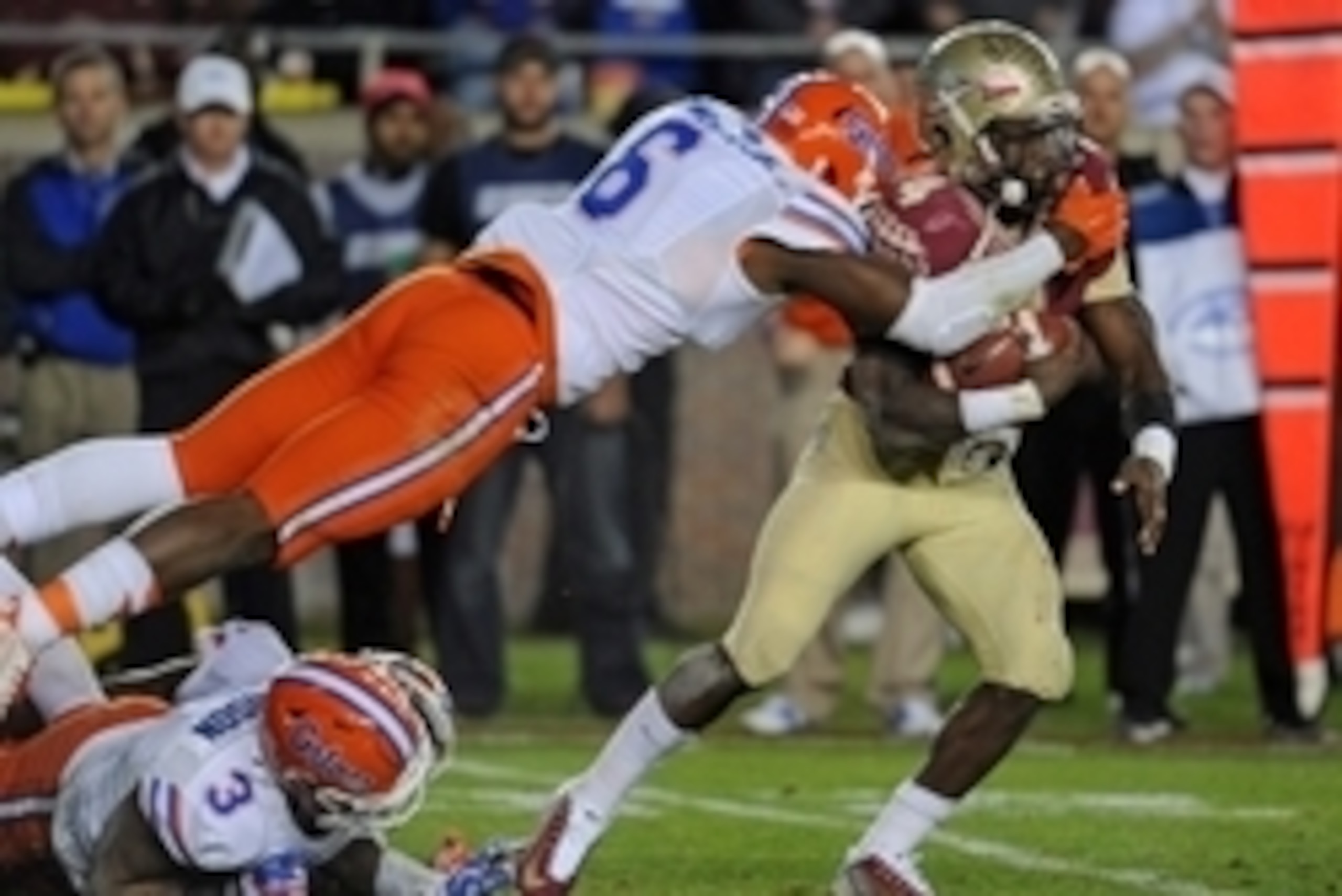 Nov 29, 2014; Tallahassee, FL, USA; Florida State Seminoles running back Dalvin Cook (4) runs the ball past Florida Gators defensive lineman Dante Fowler Jr. (6) and linebacker Antonio Morrison (3) during the game at Doak Campbell Stadium. Mandatory Credi
