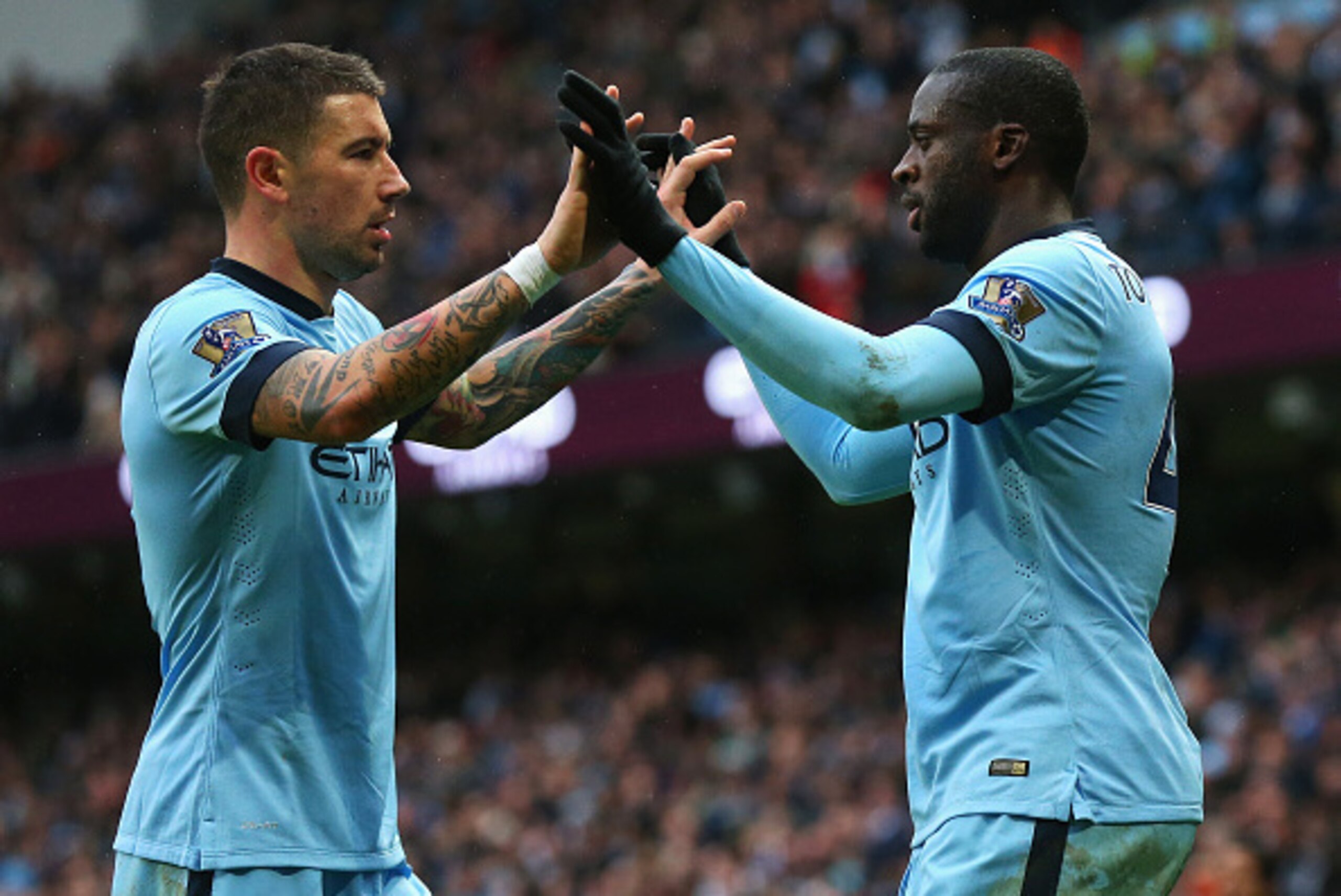 MANCHESTER, ENGLAND - DECEMBER 20: Yaya Toure (R) of Manchester City celebrates his goal with Aleksandar Kolarov of Manchester City during the Barclays Premier League match between Manchester City and Crystal Palace at Etihad Stadium on December 20, 2014 