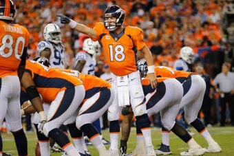 DENVER, CO - SEPTEMBER 07:  Quarterback Peyton Manning #18 of the Denver Broncos runs the offense against the Indianapolis Colts at Sports Authority Field at Mile High on September 7, 2014 in Denver, Colorado. The Broncos defeated the Colts 31-24.  (Photo