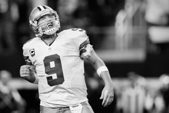 ARLINGTON, TX - JANUARY 04:  (EDITORS NOTE: Image has been converted to black and white) Quarterback Tony Romo #9 of the Dallas Cowboys reacts after the Cowboys score against the Detroit Lions in the second half during a NFC Wild Card Playoff game at AT&T