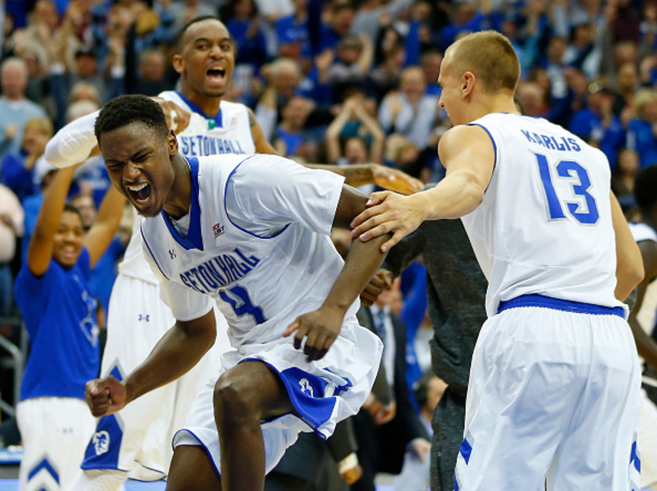 NEWARK, NJ - JANUARY 3: Sterling Gibbs #4, Brandon Mobley #2 and Haralds Karlis #13 of Seton Hall celebrate after defeating Villanova 66-61 in overtime during an NCAA college basketball game on January 3, 2015 at the Prudential Center in Newark, New Jerse