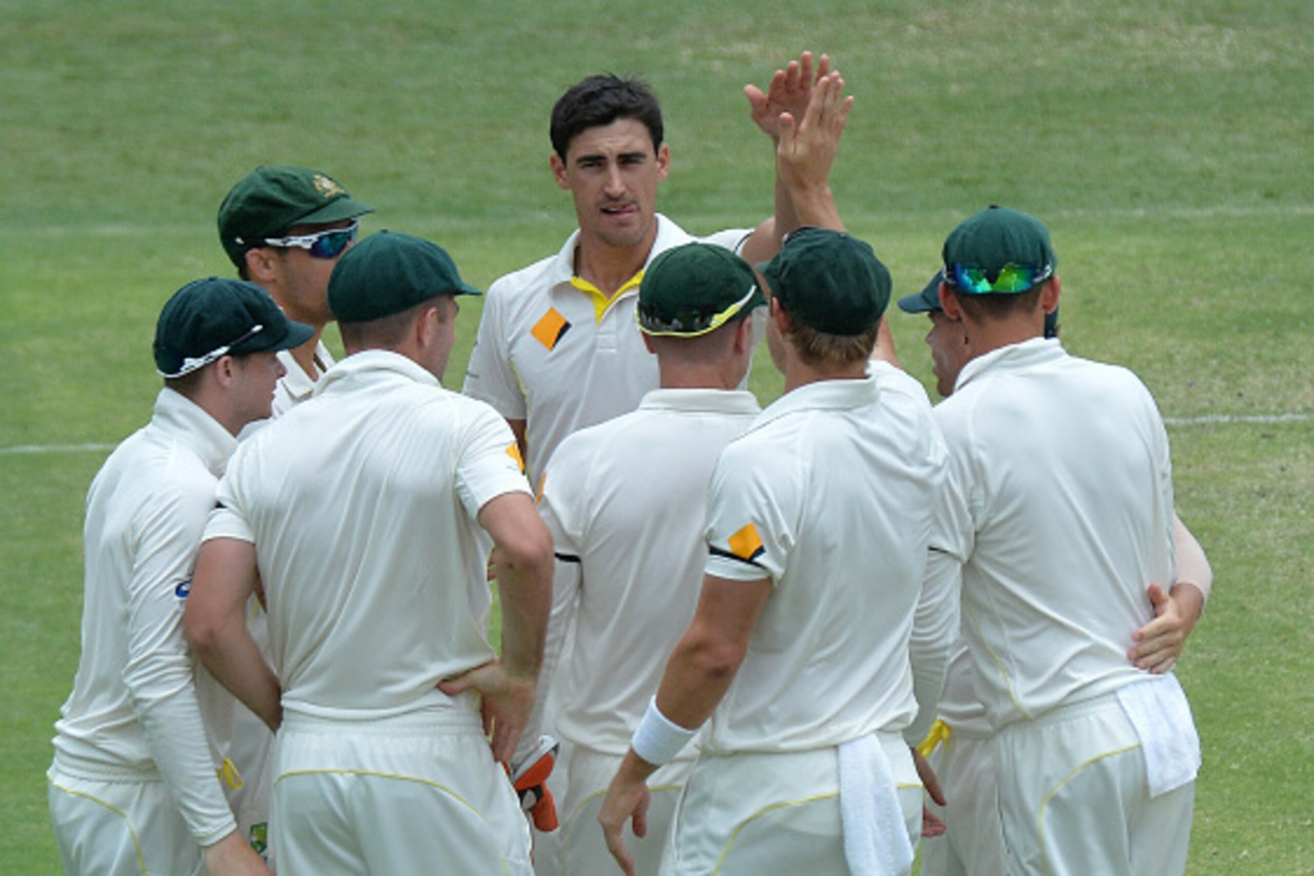 BRISBANE, AUSTRALIA - DECEMBER 20:  Mitchell Starc of Australia celebrates with team mates after taking the wicket of Ravichandran Ashwin of India during day four of the 2nd Test match between Australia and India at The Gabba on December 20, 2014 in Brisb