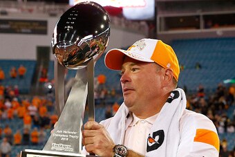 JACKSONVILLE, FL - JANUARY 02:  Head coach Butch Jones of the Tennessee Volunteers poses with the championship trophy following the TaxSlayer Bowl against the Iowa Hawkeyes at EverBank Field on January 2, 2015 in Jacksonville, Florida.  The Tennessee Volu