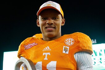 JACKSONVILLE, FL - JANUARY 02:  Joshua Dobbs #11 of the Tennessee Volunteers poses with the MVP trophy following the TaxSlayer Bowl against the Iowa Hawkeyes at EverBank Field on January 2, 2015 in Jacksonville, Florida.  The Tennessee Volunteers defeated