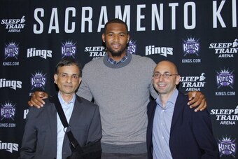 SACRAMENTO, CA - SEPTEMBER 30: Vivek Ranadive', Demarcus Cousins, and Pete D'Alessandro pose for a photo before the media as The Sacramento Kings sign Demarcus to a contract extension on September 30, 2013 at the Kings practice facility in Sacramento, Cal