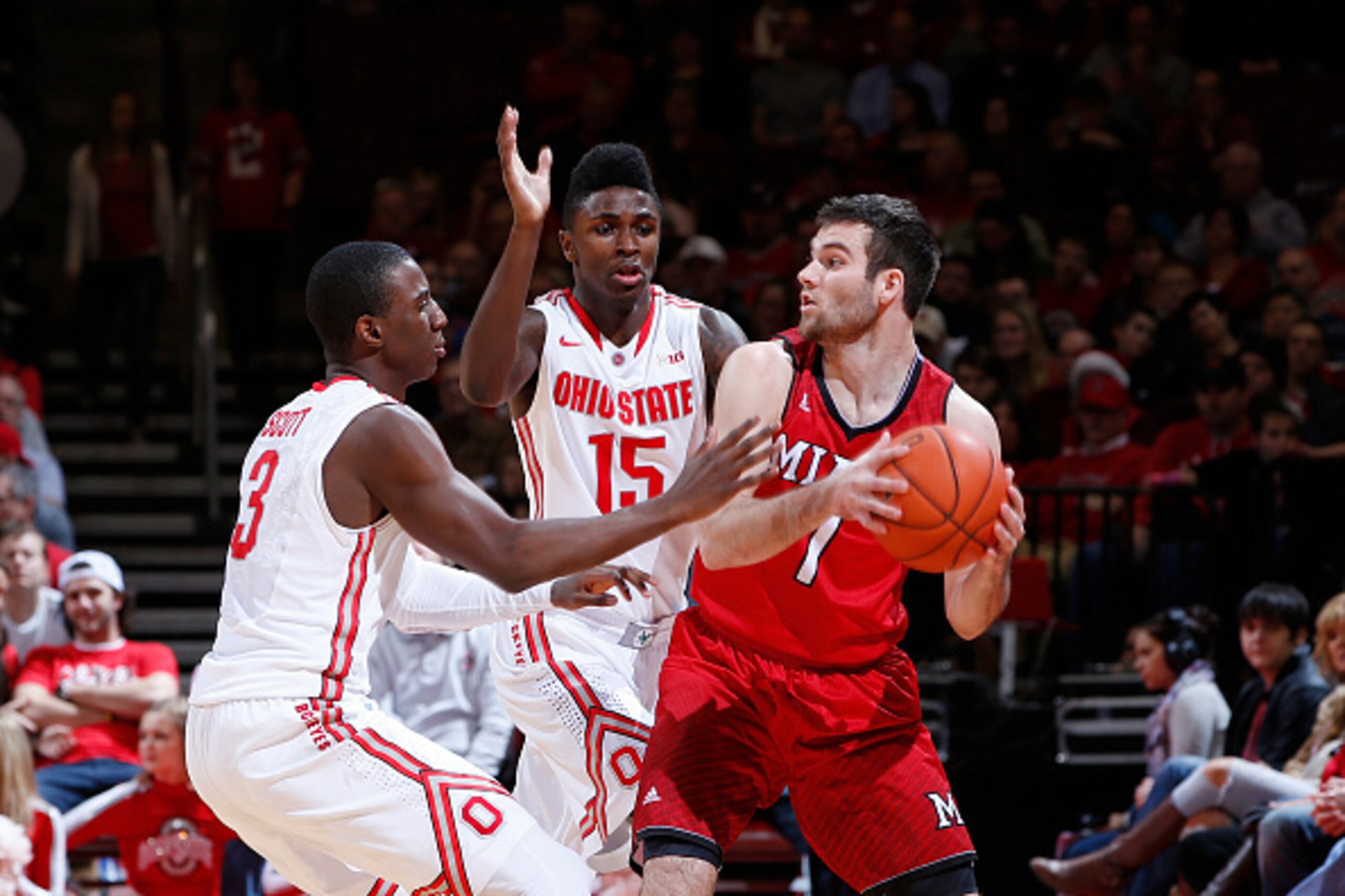 COLUMBUS, OH - DECEMBER 22: Shannon Scott #3 and Kam Williams #15 of the Ohio State Buckeyes defend against Zach McCormick #1 of the Miami Redhawks during the game at Value City Arena on December 22, 2014 in Columbus, Ohio. The Buckeyes defeated the Redha
