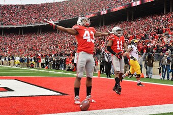 COLUMBUS, OH - NOVEMBER 29:  Darron Lee #43 of the Ohio State Buckeyes celebrates after returning a recovered fumble 33-yards for a touchdown in the fourth quarter against the Michigan Wolverines at Ohio Stadium on November 29, 2014 in Columbus, Ohio. Ohi