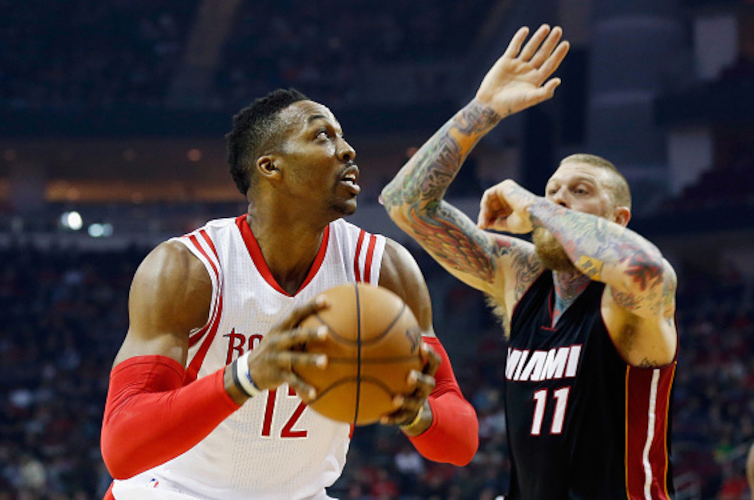 HOUSTON, TX - JANUARY 03:   Dwight Howard #12 of the Houston Rockets looks to go to the basket as Chris Andersen #11 of the Miami Heat defends during their game at the Toyota Center on January 3, 2015 in Houston, Texas.  NOTE TO USER: User expressly ackno