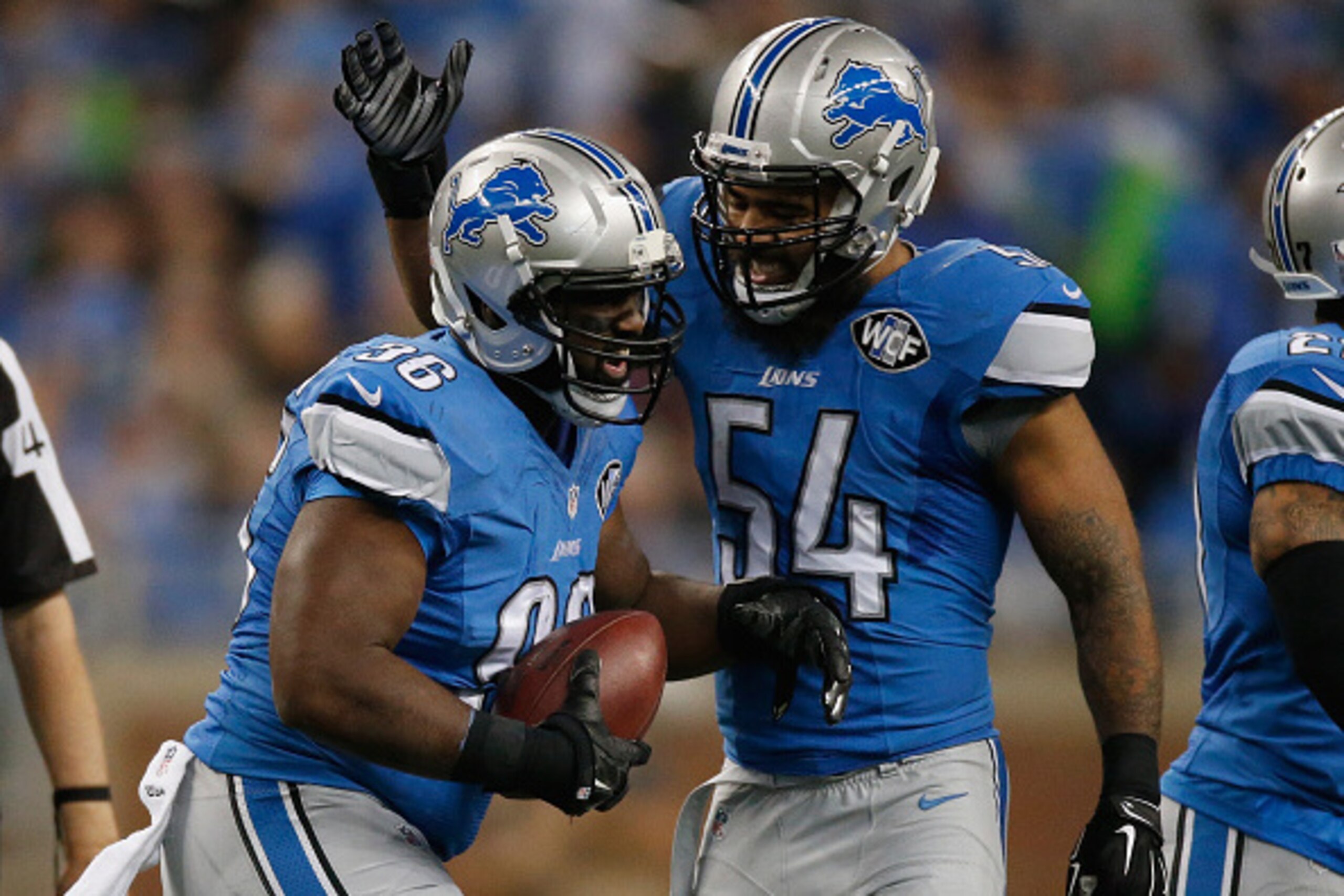 DETROIT, MI - DECEMBER 07: Andre Fluellen #96 and DeAndre Levy #54 of the Detroit Lions reacts to a second quarter fumble while playing the Tampa Bay Buccaneers at Ford Field on December 07, 2014 in Detroit, Michigan. (Photo by Gregory Shamus/Getty Images