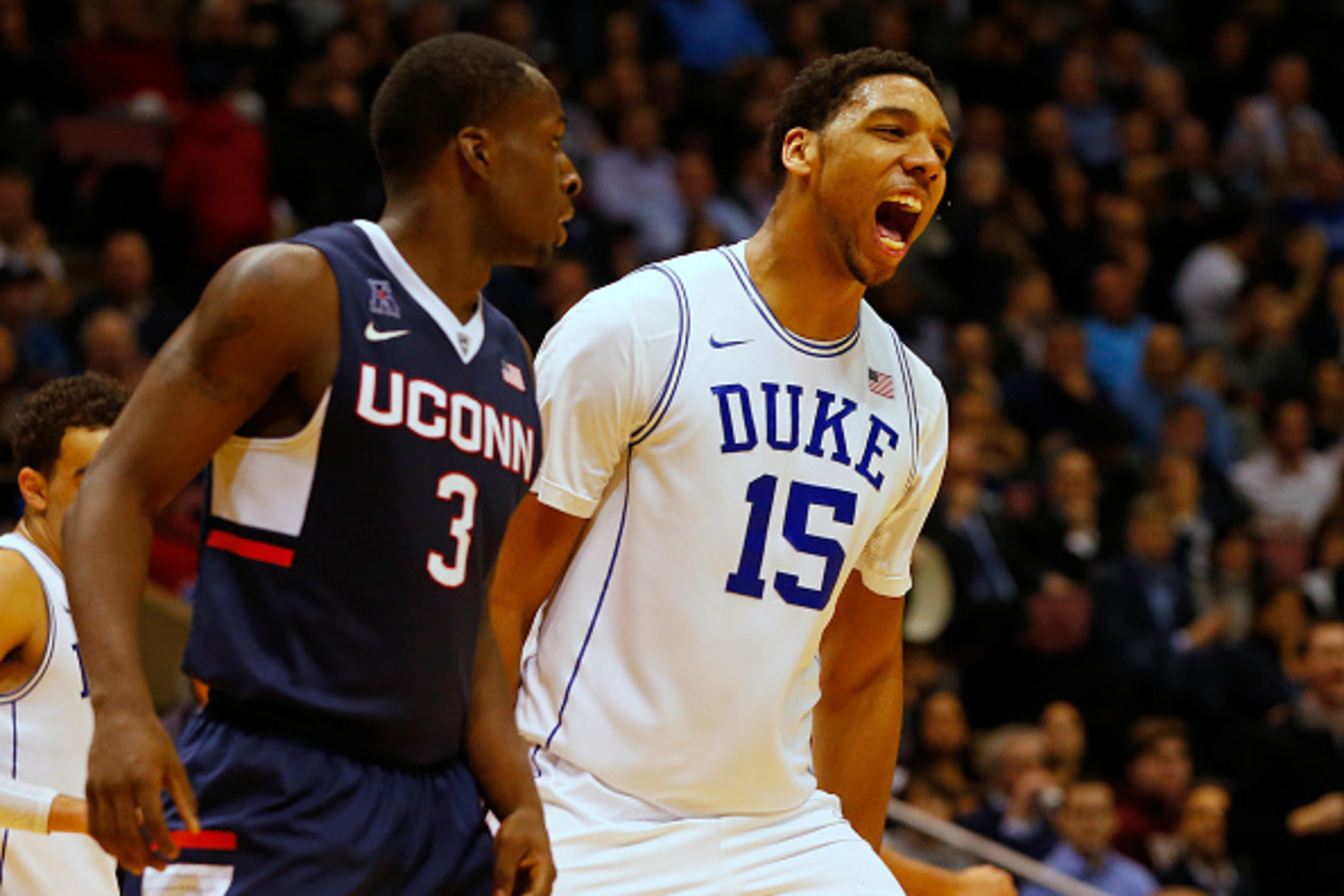 EAST RUTHERFORD, NJ - DECEMBER 18: Jahlil Okafor #15 of the Duke Blue Devils reacts after scoring a basket as Terrence Samuel #3 of the Connecticut Huskies looks on during the second half of an NCAA college basketball game on December 18, 2014 at the Izod