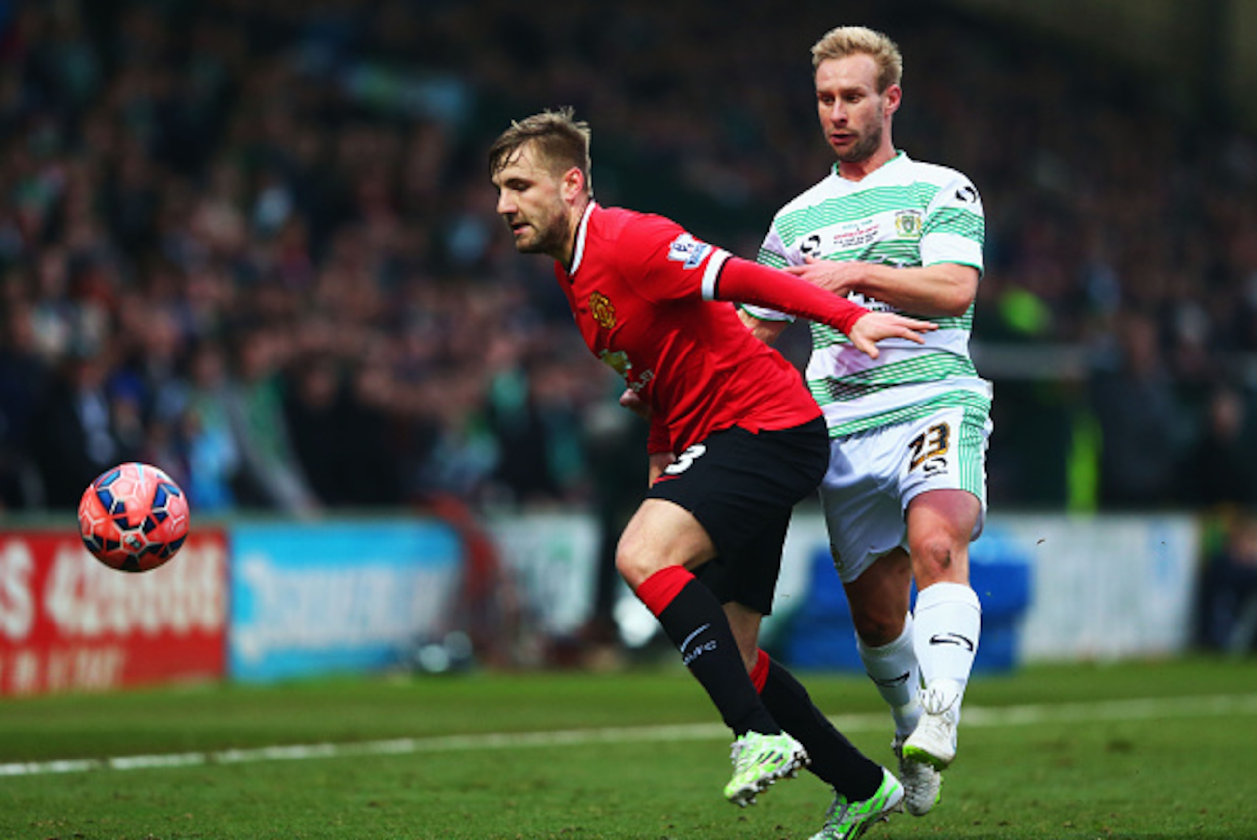 YEOVIL, ENGLAND - JANUARY 04: Luke Shaw of Manchester United holds off Simon Gillett of Yeovil Town during the FA Cup Third Round match between Yeovil Town and Manchester United at Huish Park on January 4, 2015 in Yeovil, England. (Photo by Michael Stee YEOVIL, ENGLAND - JANUARY 04: Luke Shaw of Manchester United holds off Simon Gillett of Yeovil Town during the FA Cup Third Round match between Yeovil Town and Manchester United at Huish Park on January 4, 2015 in Yeovil, England. (Photo by Michael Stee
