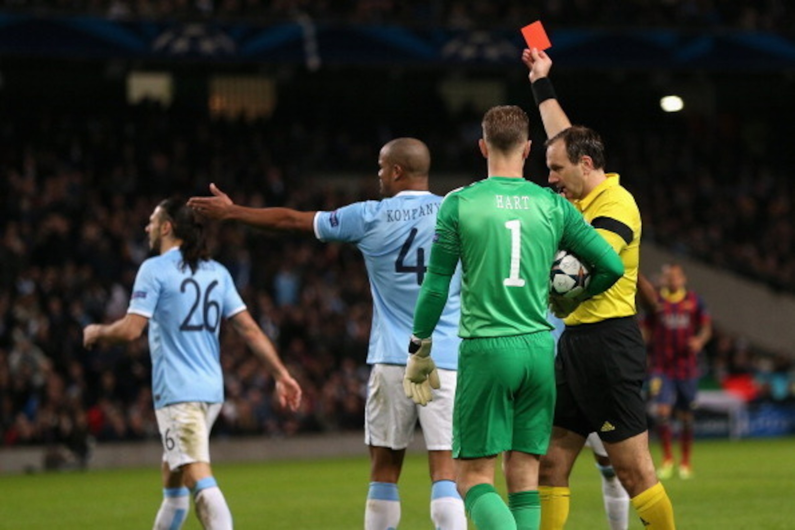 MANCHESTER, ENGLAND - FEBRUARY 18:  Referee Jonas Eriksson shows a red card to Martin Demichelis of Manchester City during the UEFA Champions League Round of 16 first leg match between Manchester City and Barcelona at the Etihad Stadium on February 18, 20
