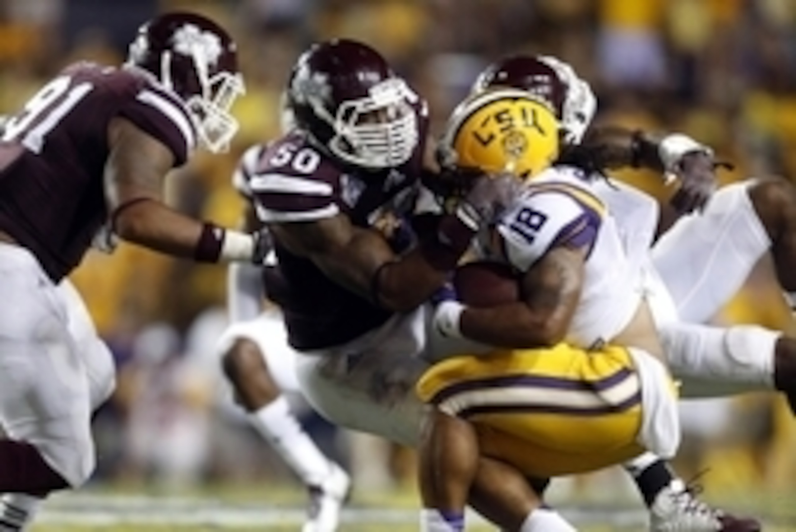Sep 20, 2014; Baton Rouge, LA, USA; Mississippi State Bulldogs linebacker Benardrick McKinney (50) tackles LSU Tigers running back Terrence Magee (18) during the second half of a game at Tiger Stadium. Mississippi State defeated LSU 34-29. Mandatory Credi