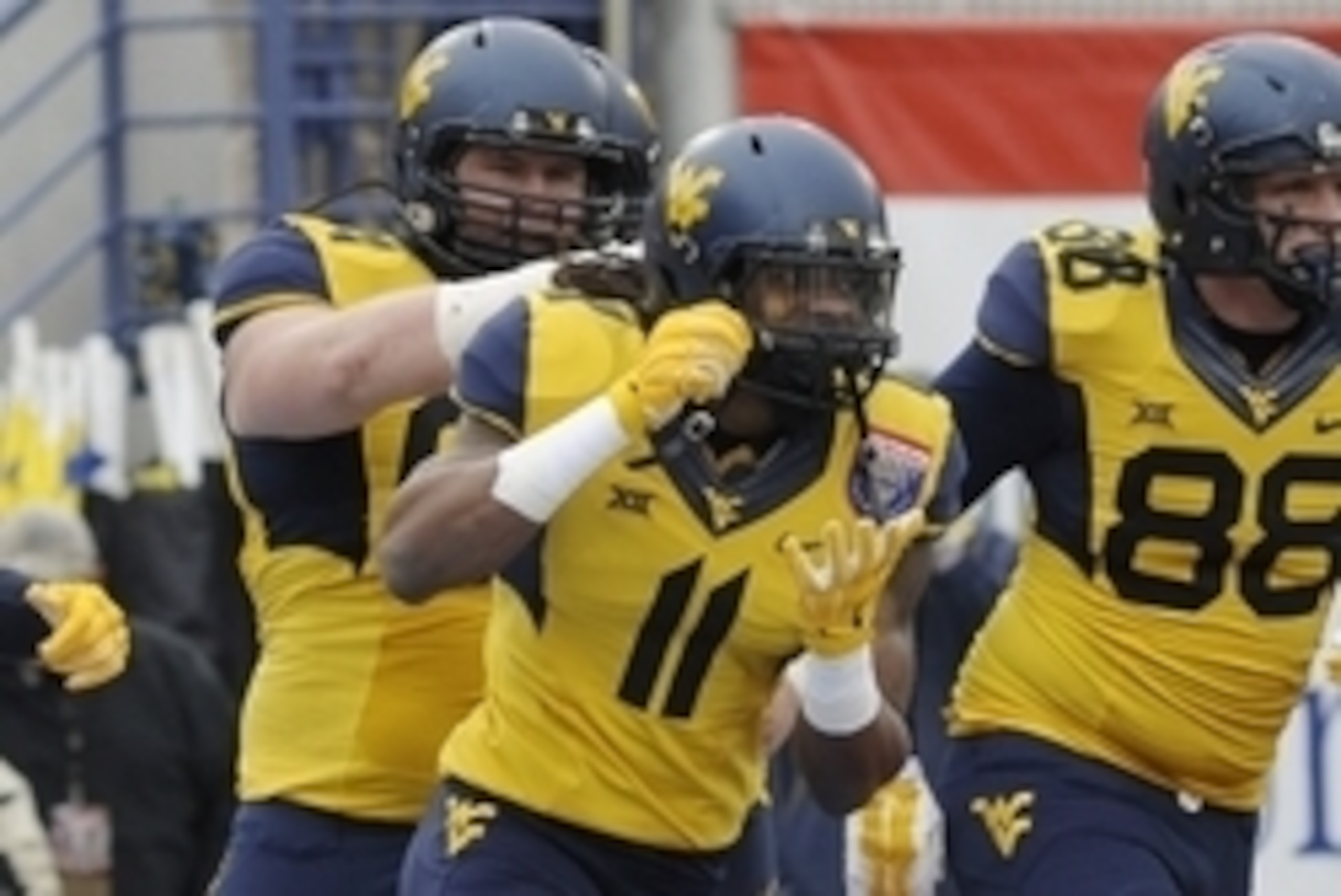 Dec 29, 2014; Memphis, TN, USA; West Virginia Mountaineers wide receiver Kevin White (11) celebrates after scoring a touchdown during the game against the Texas A&M Aggies in the 2014 Liberty Bowl at Liberty Bowl Memorial Stadium. Mandatory Credit: Justin