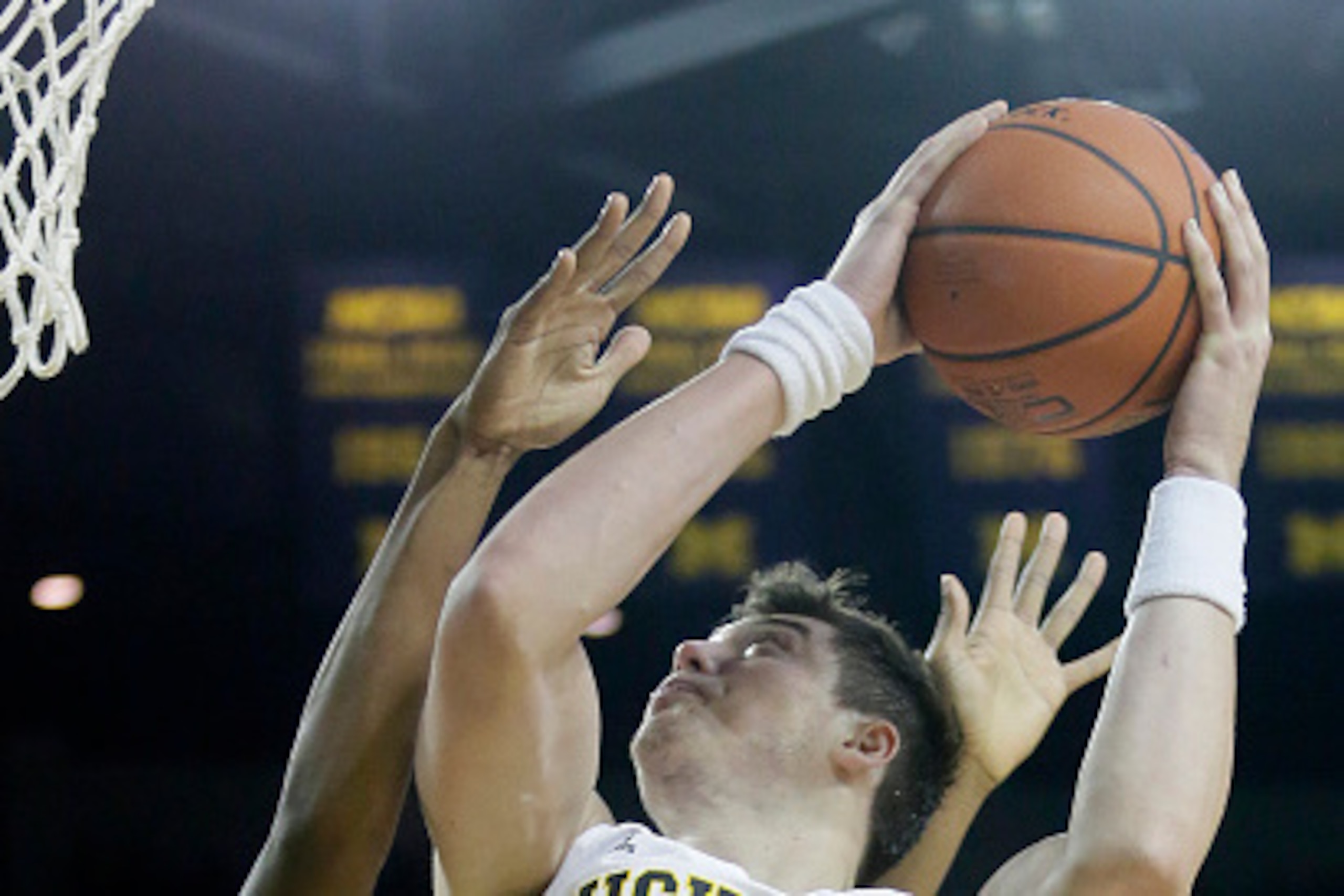 ANN ARBOR, MI - DECEMBER 22:  Ricky Doyle #32 of the Michigan Wolverines goes to the basket against Arnold Fripp #3 of the Coppin State University Eagles during the first half at Crisler Arena on December 22, 2014 in Ann Arbor, Michigan. Doyle led Michiga
