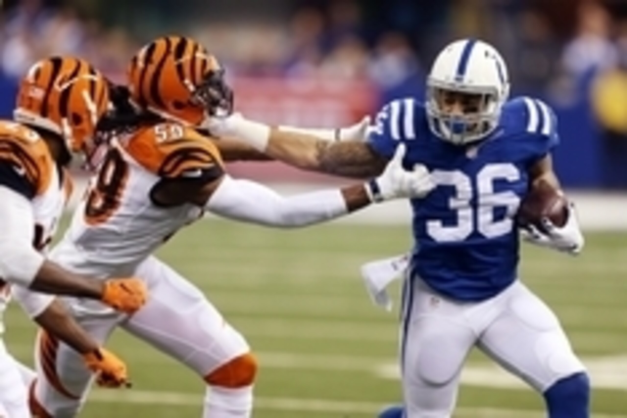 Jan 4, 2015; Indianapolis, IN, USA; Indianapolis Colts running back Dan Herron (36) is tackled by Cincinnati Bengals outside linebacker Emmanuel Lamur (59) in the first quarter in the 2014 AFC Wild Card playoff football game at Lucas Oil Stadium. Mandator