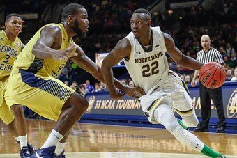 SOUTH BEND, IN - JANUARY 03: Jerian Grant #22 of the Notre Dame Fighting Irish drives to the basket against Demarco Cox #4 of the Georgia Tech Yellow Jackets at Purcell Pavilion on January 3, 2015 in South Bend, Indiana. (Photo by Michael Hickey/Getty Ima