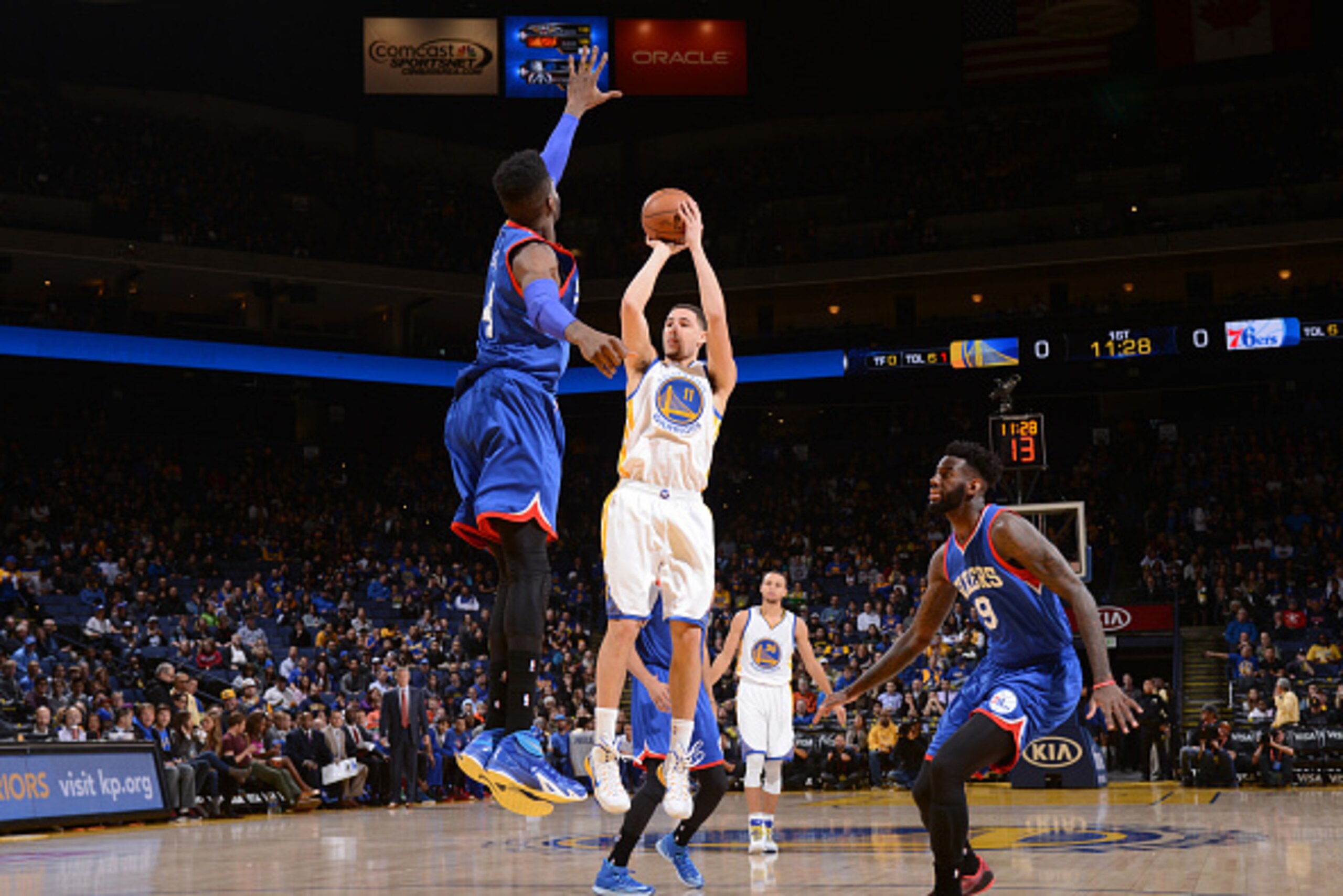 OAKLAND, CA - DECEMBER 30: Klay Thompson #11 of the Golden State Warriors shoots against Nerlens Noel #4 of the Philadelphia 76ers on December 30, 2014 at Oracle Arena in Oakland, California. NOTE TO USER: User expressly acknowledges and agrees that, by d