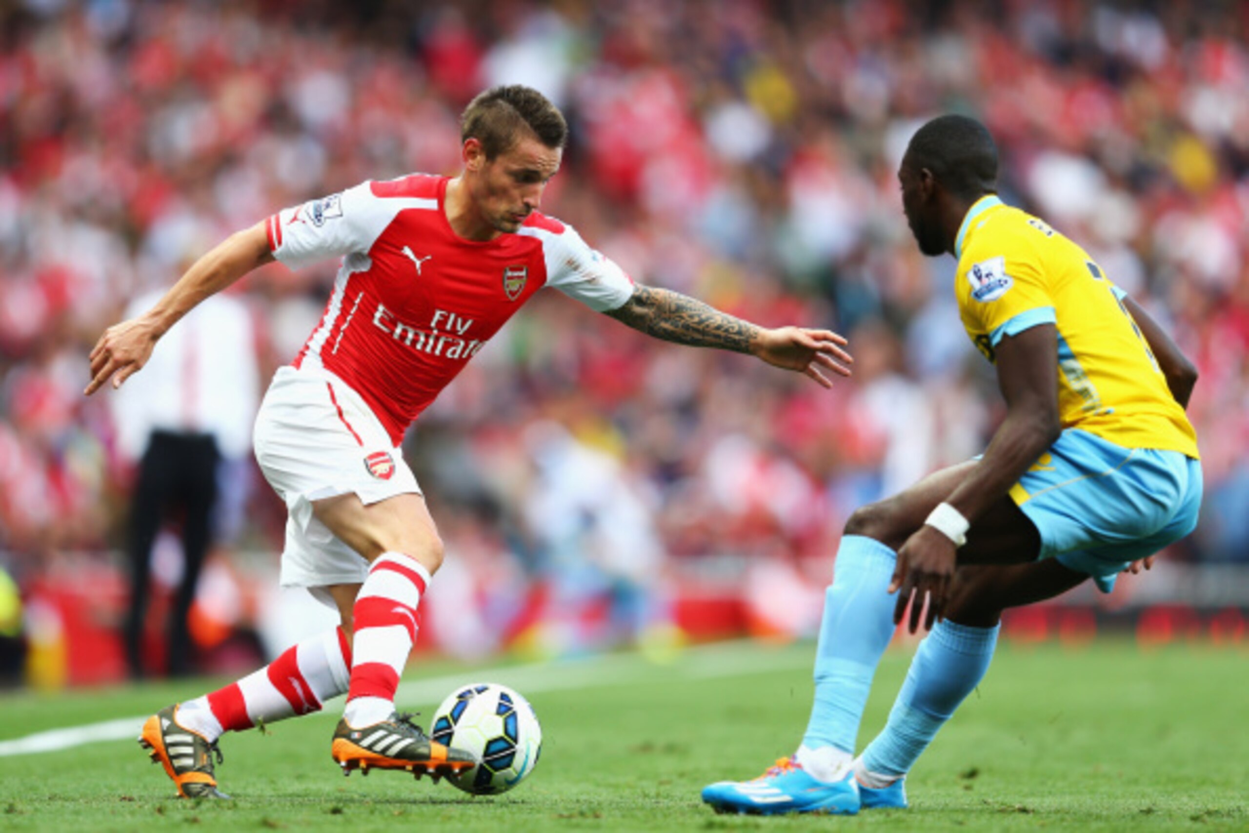 LONDON, ENGLAND - AUGUST 16: Mathieu Debuchy of Arsenal takes on Yannick Bolasie of Crystal Palace during the Barclays Premier League match between Arsenal and Crystal Palace at Emirates Stadium on August 16, 2014 in London, England.  (Photo by Clive Maso