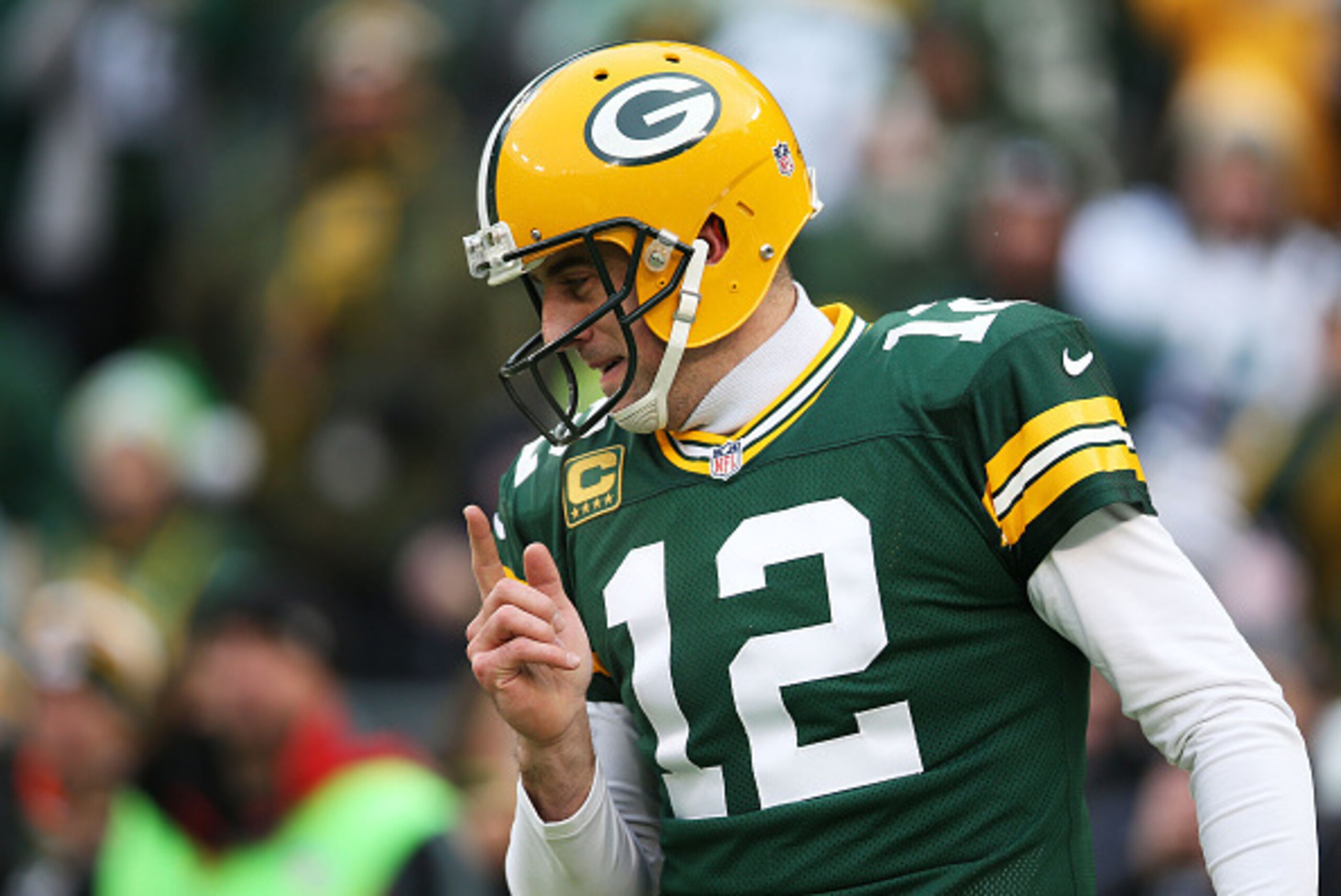GREEN BAY, WI - DECEMBER 28:  Aaron Rodgers #12 of the Green Bay Packers reacts in the first quarter against the Detroit Lions at Lambeau Field on December 28, 2014 in Green Bay, Wisconsin.  (Photo by Chris Graythen/Getty Images)